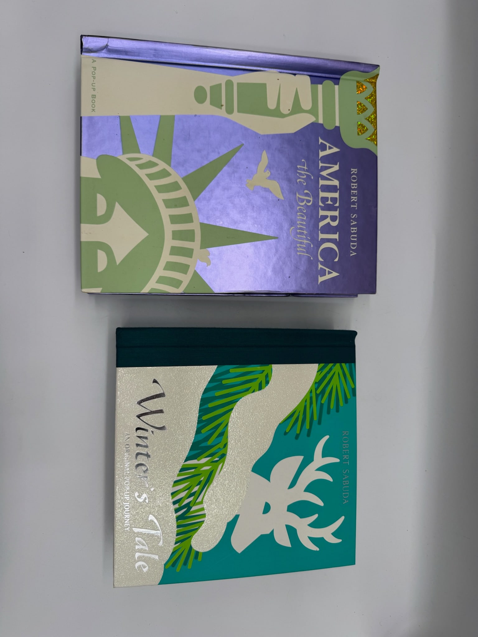 Robert Sabuda Pop-Up Books: America the Beautiful & Winter's Tale: Award-winning collectible Robert Sabuda pop-up books: "America the Beautiful" and "Winter's Tale." Both are described as classic collectible pop-up books.