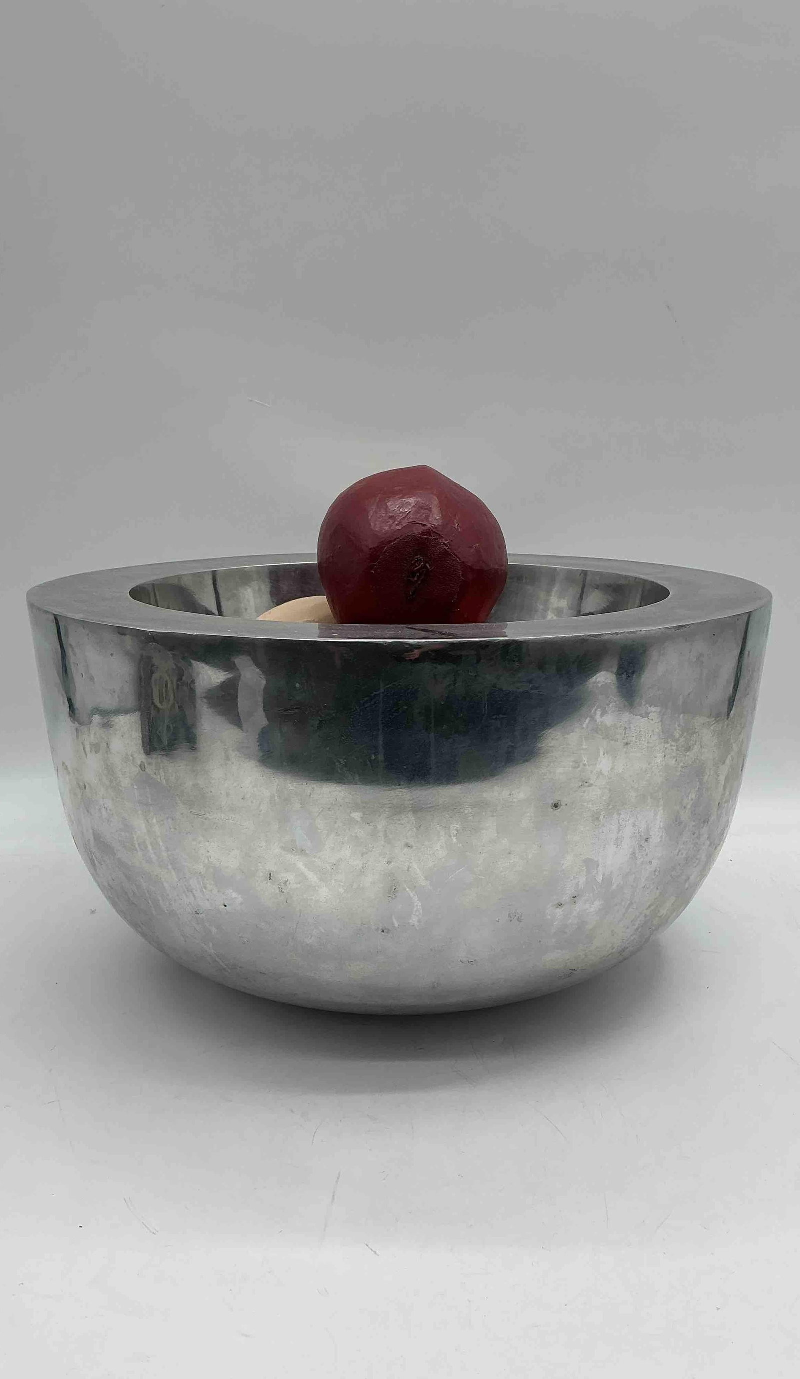 Metal Bowl with Painted Wooden Fruits: Decorative silver tone metal bowl containing assorted hand painted wooden fruits in red, orange, and beigeMedium: metal and wood Dimensions: H8in Diameter 15in
