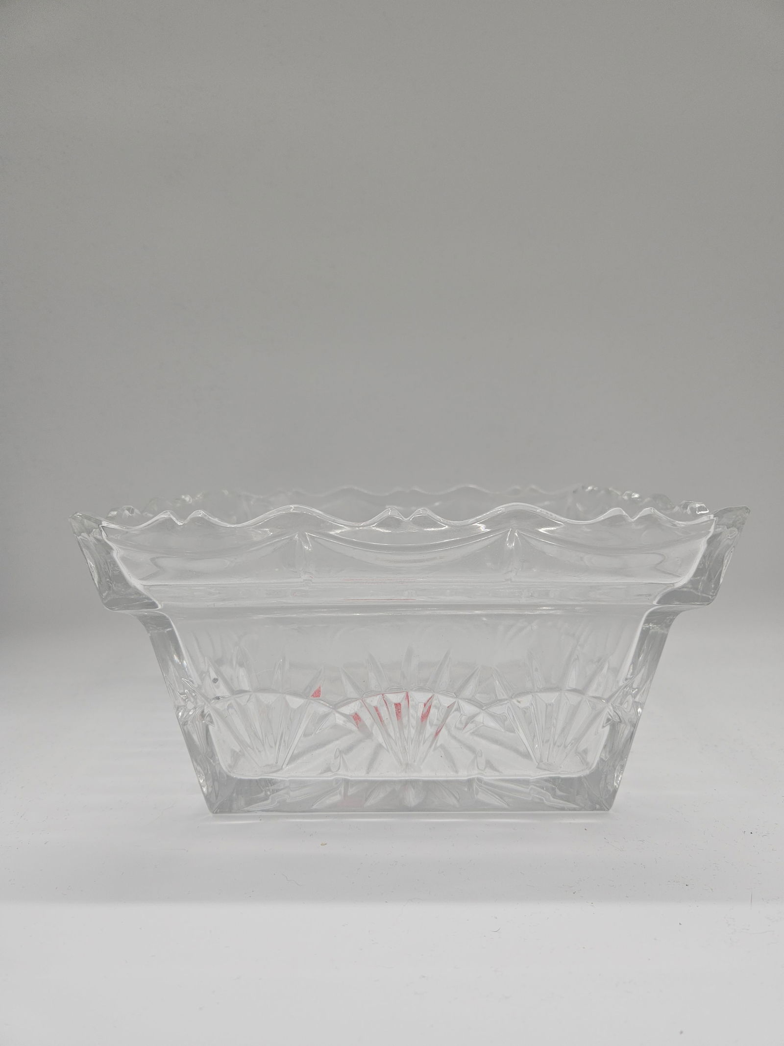 Cut Glass Square Bowl: Square cut glass bowl with decorative scalloped rim. Dimensions: H: 5in, W: 9in, L: 9in.