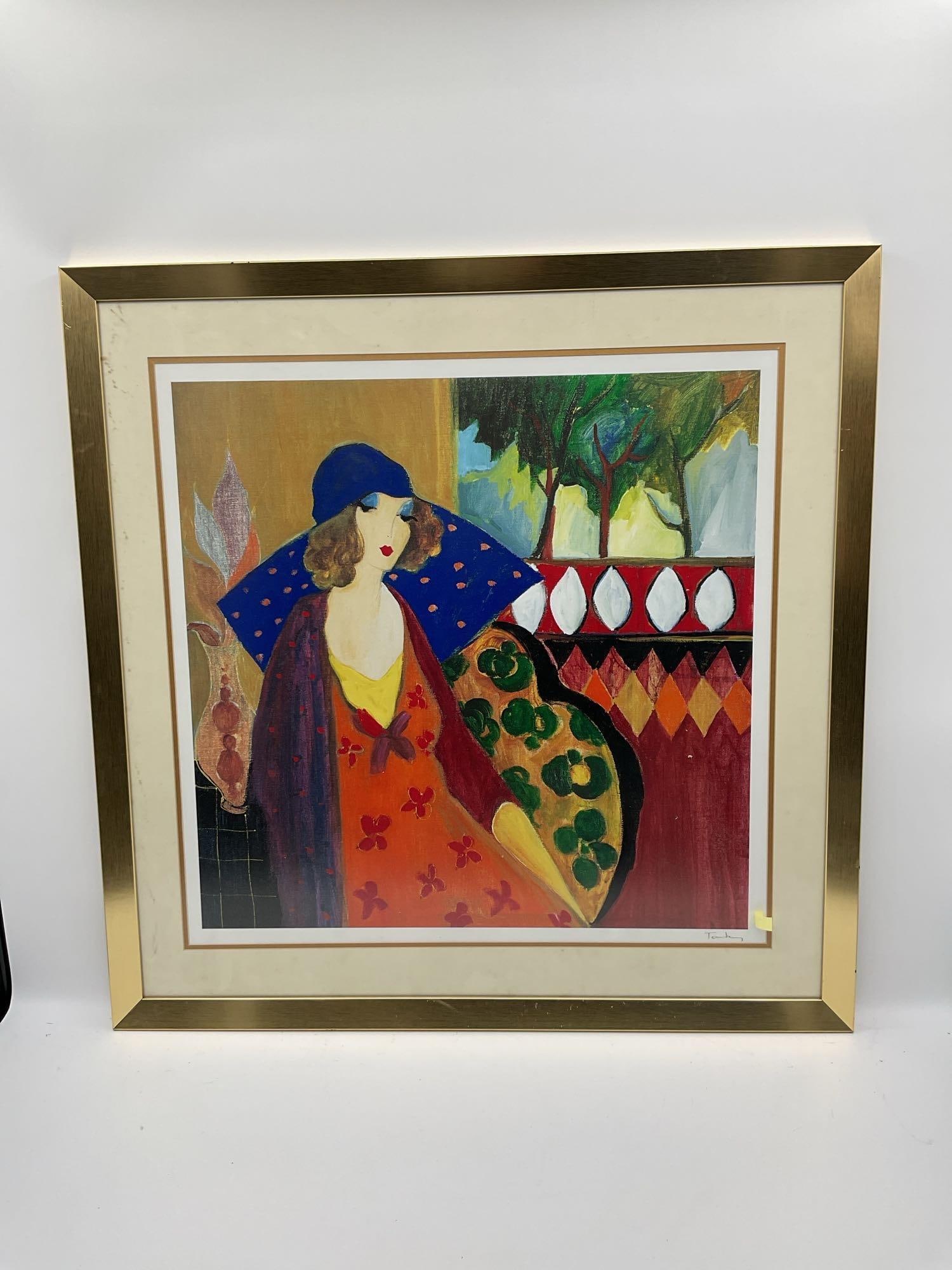 Indigo Chapeau by Tarkay with C.O.A.: Description: Elegant woman in a blue hat seated before a vibrant geometric and nature-inspired backdrop. A classic example of Tarkay’s colorful and expressive portrait style. Medium: 