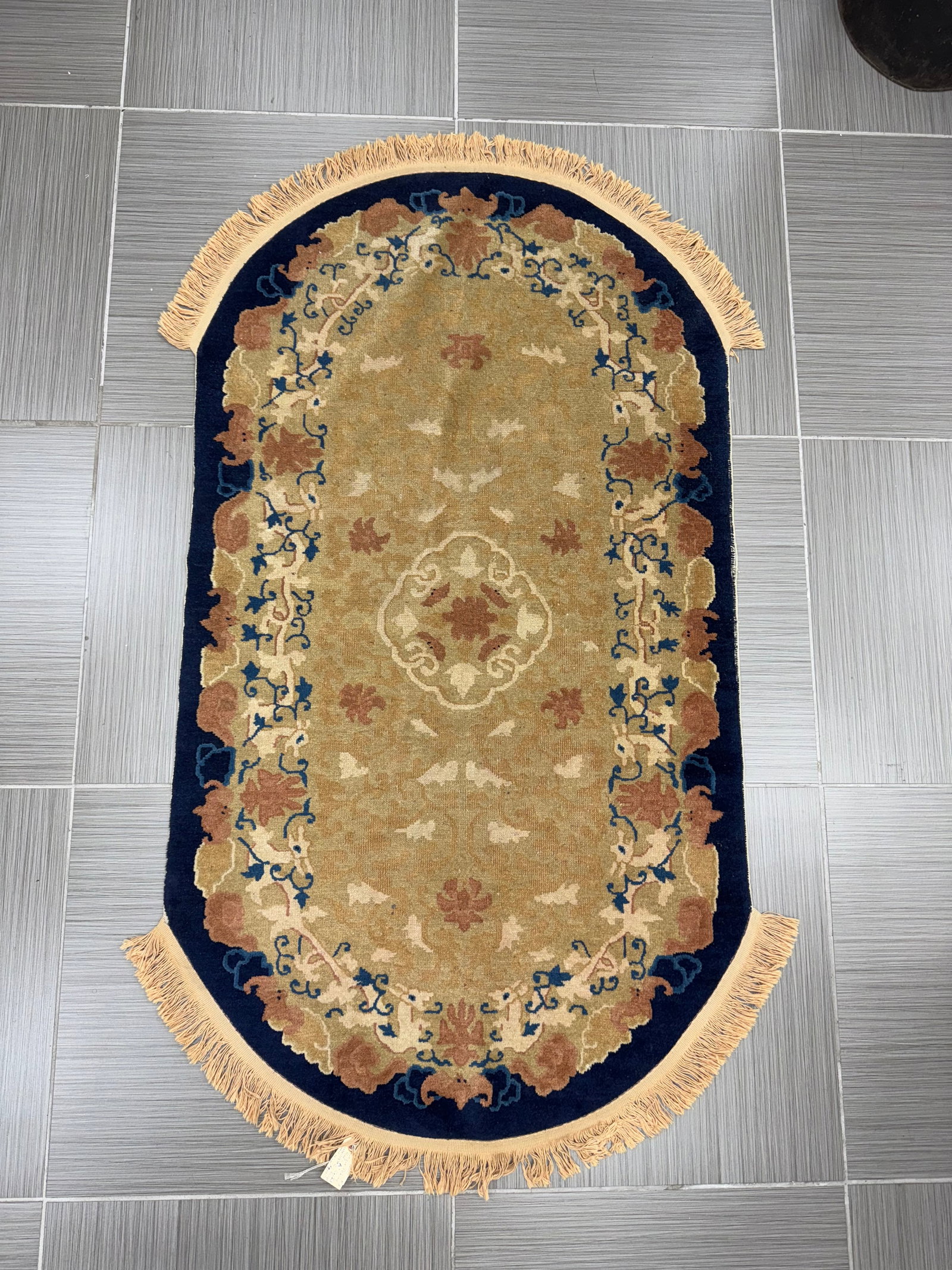 Antique Peking Wool Rug, Late 19th Century: Antique Peking rug, late 19th century. Wool. The rug features a central medallion design with floral and geometric motifs in shades of beige, brown, and blue on a dark blue ground. New fringe. Dimensi