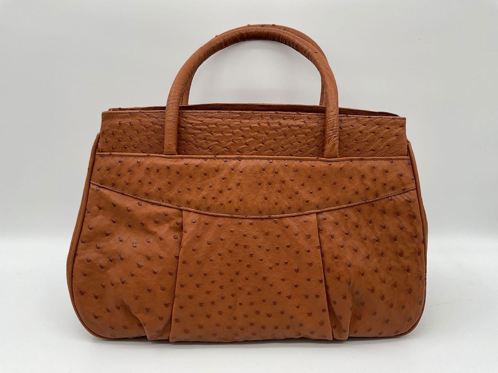 Genuine Ostrich Leather Handbag - Lisa Barfield: Structured brown handbag crafted from authentic ostrich leather, featuring characteristic quill bumps and dual rounded top handles. Likely handmade or boutique-crafted, with exterior pockets for conve