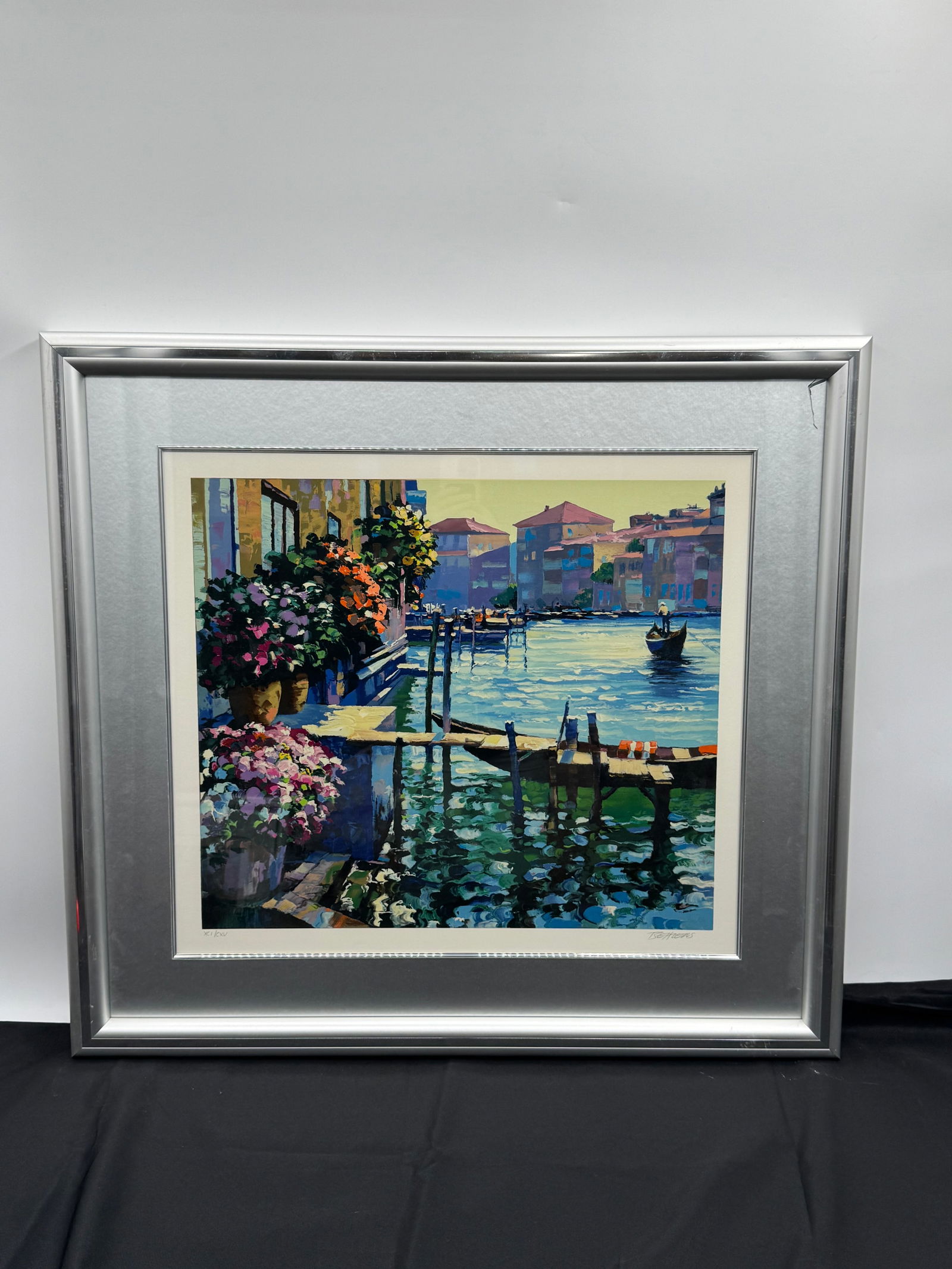 Venice Suite by the American artist Howard Behrens (1933-2014) w/ COA: Framed print by T. Bearens depicting a Venetian canal scene with flowers. Signed lower right. Numbered XCI/CXV lower left. Image size approximately 19.5 x 19.5 inches. Frame measures 31 x 28.5 inches.