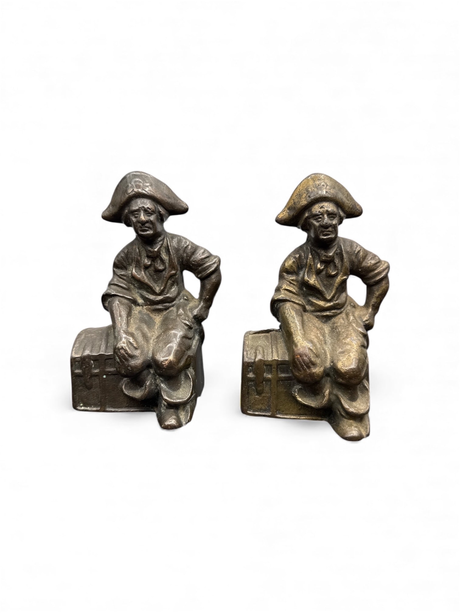 Pair of Bronze Pirate Bookends: Pair of bronze bookends depicting pirates sitting on treasure chests. Each measures approximately H:6in L:3in W:2in