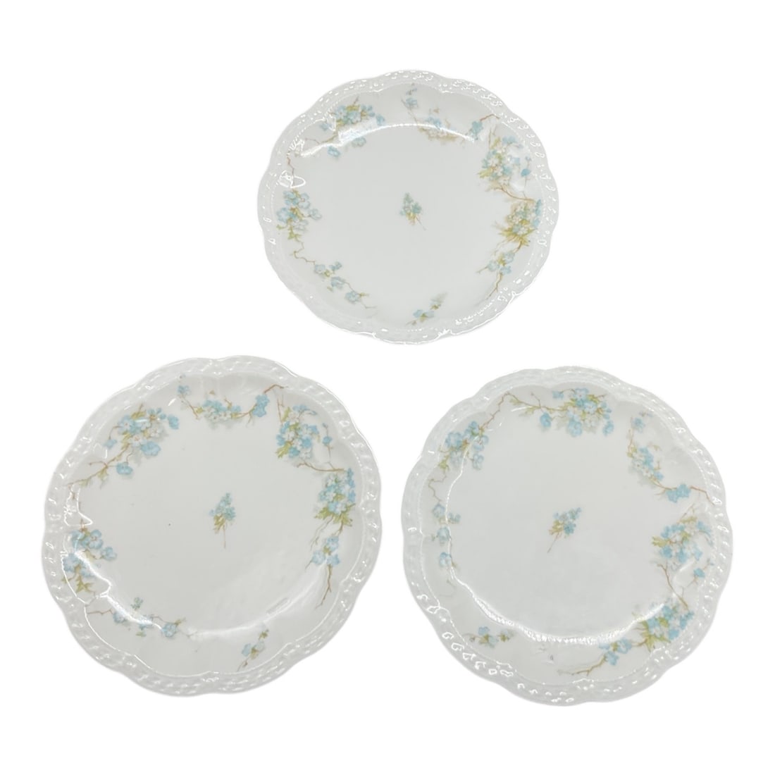 Haviland and Company Limoges Porcelain Floral Plates Set of Three: This refined set of three French porcelain plates was produced by Haviland and Company of Limoges and showcases a delicate floral motif rendered in soft pastel tones with elegant scalloped rims.