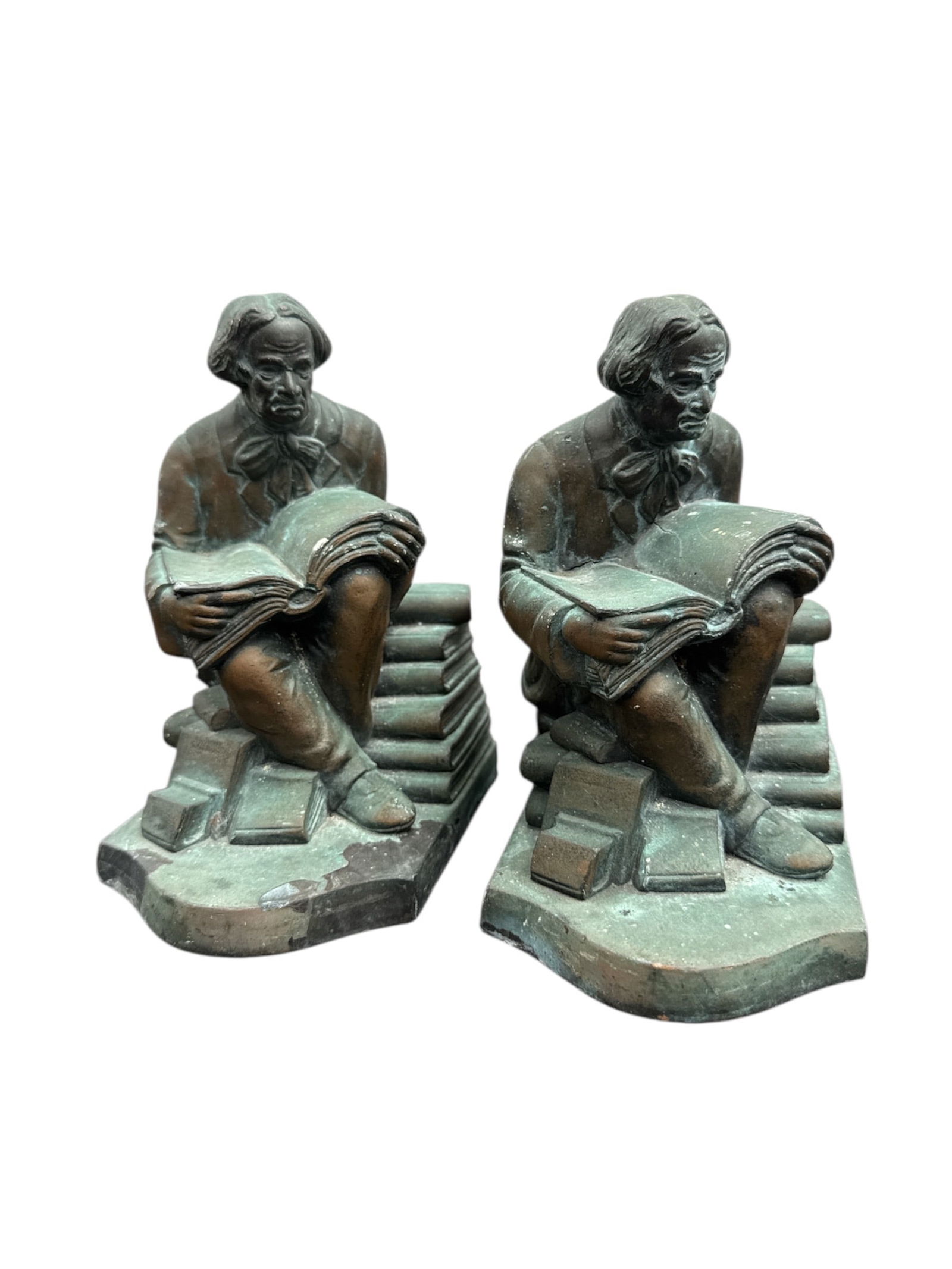 Pair of Bronze Tone Elbert Hubbard Sculptures / Bookends: Pair of Elbert Hubbard rendered in a bronze-tone finish. Each figure is modeled with expressive facial features and detailed clothing, seated atop a stepped base with books at their feet. The