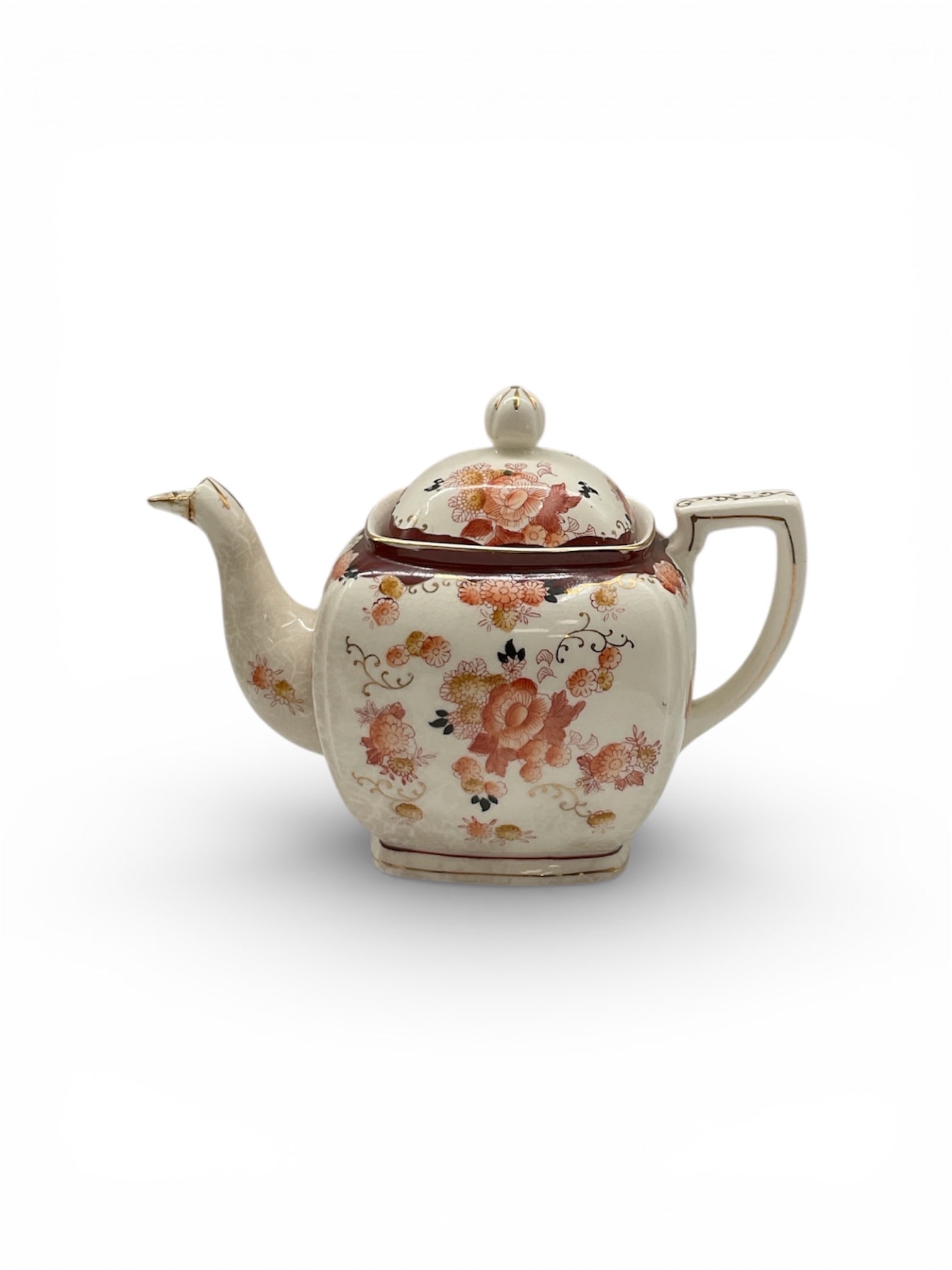 Hand Painted Japan Porcelain Teapot with Floral Decoration: This decorative porcelain teapot was hand painted in Japan and features a softly crackled ivory ground decorated with floral motifs in warm shades of coral, peach, and gold. The rounded body is
