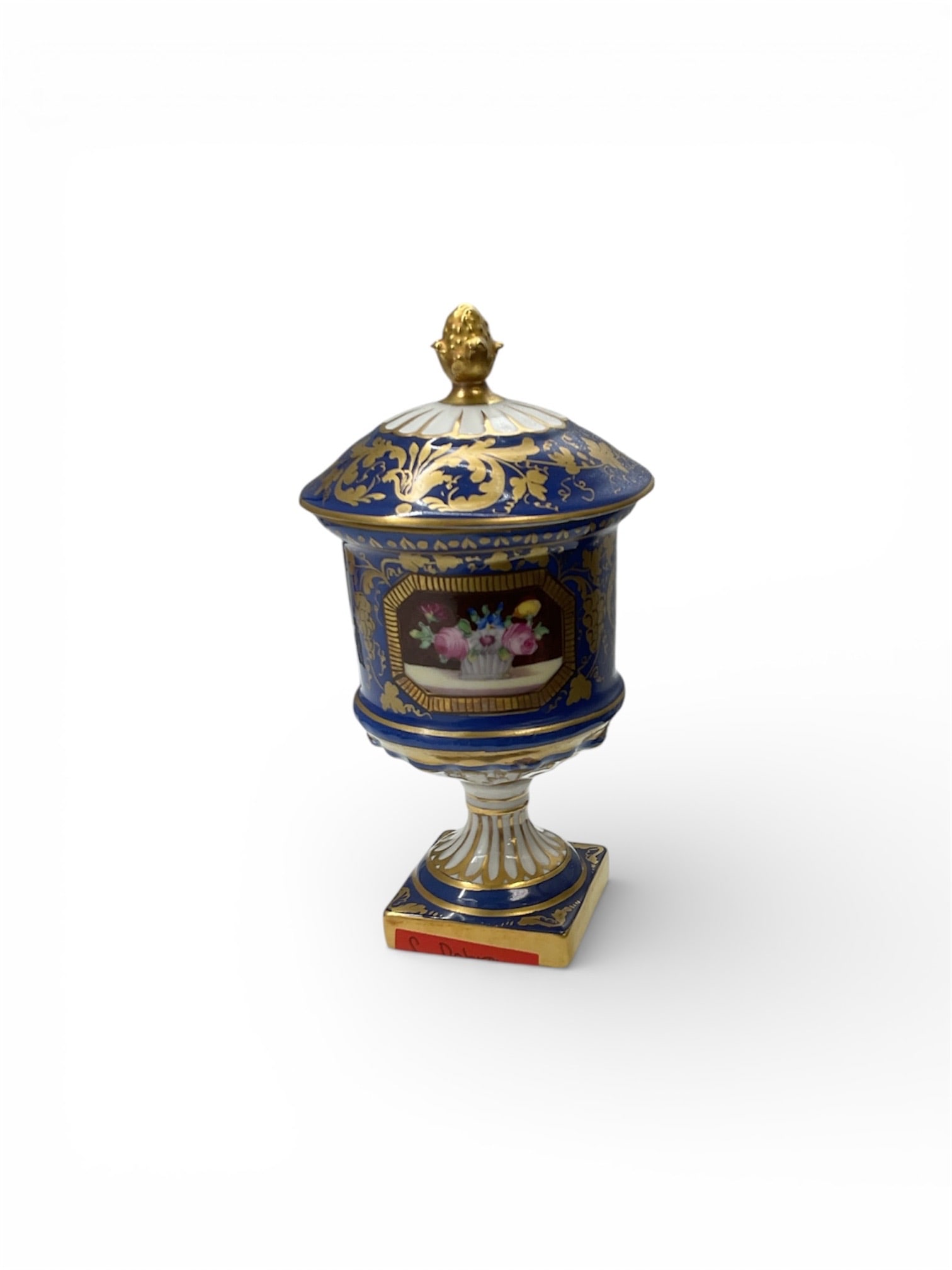 Decorative Porcelain Urn with Lid and Cobalt Blue Ground with Gilt Decoration: This decorative porcelain urn features a classical lidded form raised on a square pedestal base, richly decorated with a deep cobalt blue ground and extensive gilt ornamentation. The body is