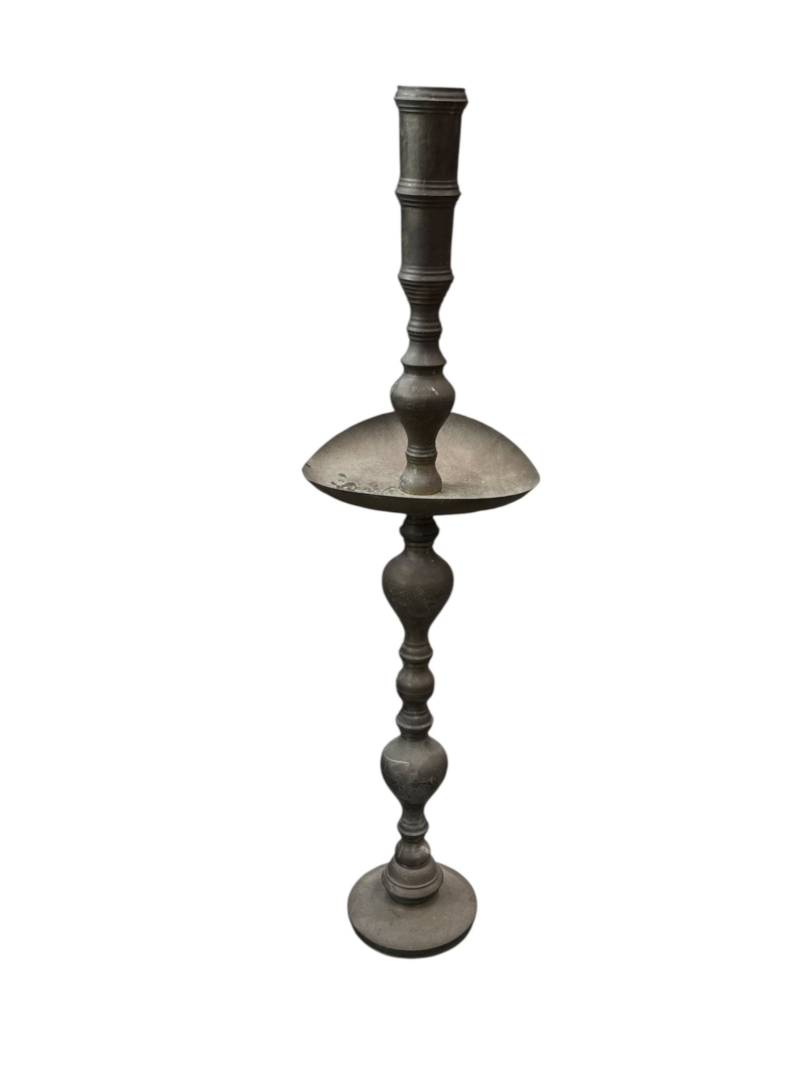 Tall Brass Floor Candlestick Stand: Tall brass floor candlestick stand featuring a turned baluster-style column with a circular drip tray and round base. The surface displays a warm aged patina, giving the piece a traditional and elegan
