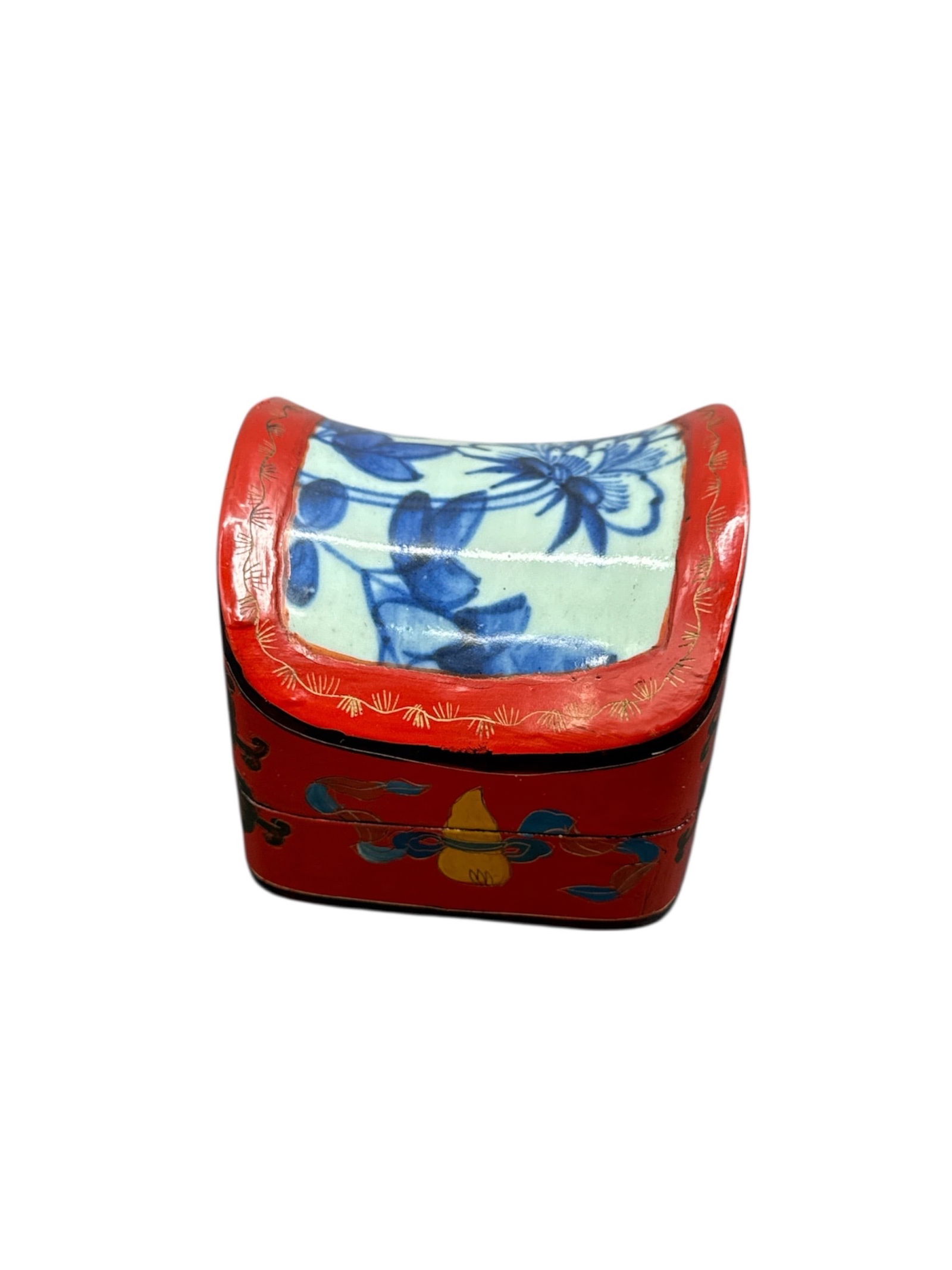 Decorative Hand Painted Lidded Trinket Box: Decorative hand painted trinket box featuring a square form with a domed lid and vibrant red ground accented with floral and decorative motifs. The interior consists of two fitted compartments,