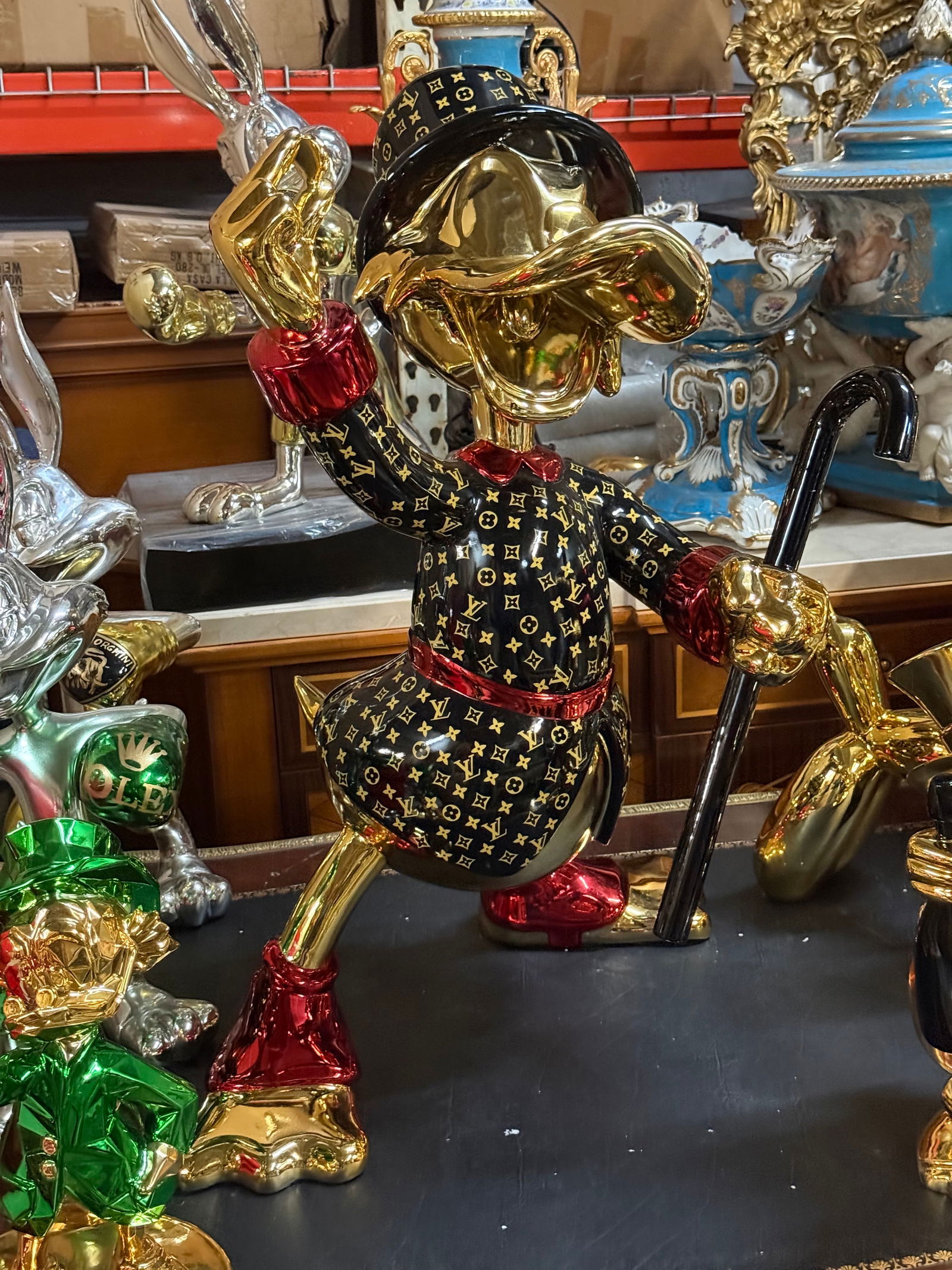 Statement Piece: Exclusive Pop Art Scrooge McDuck Sculpture – Gold & LV-Inspired Pattern: Description: This stunning, custom-made Scrooge McDuck pop art sculpture is a true conversation starter and an eye-