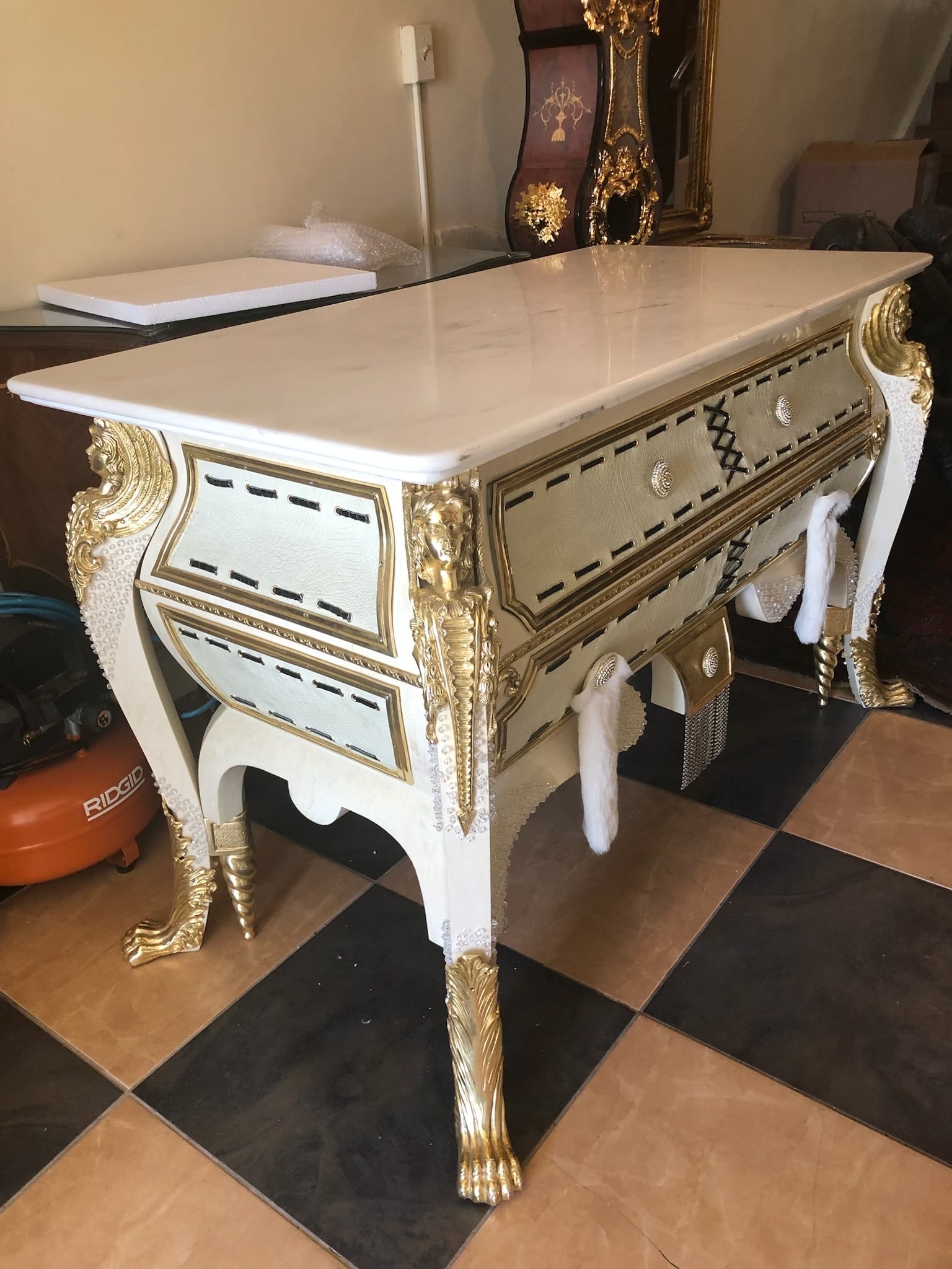 Magnificent Italian Rococo Style Giltwood and Marble-Top Console Table: Description This magnificent console table embodies opulent European craftsmanship with its lavish hand-carved details and elegant finish. The piece features a high-quality white marble top set above