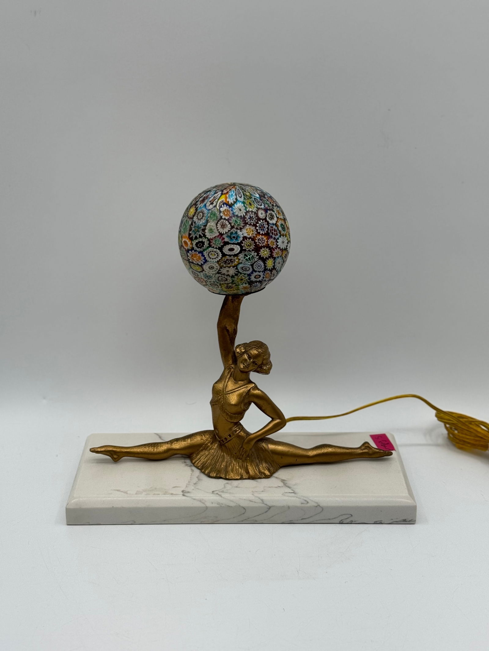 Vintage Art Deco Bronze Ballerina Figural Lamp on Marble Base: Description: Charming vintage Art Deco figural lamp featuring a bronze-toned ballerina posed in a dramatic full split, her raised arm holding a small light socket like a torch. The dancer is rendered
