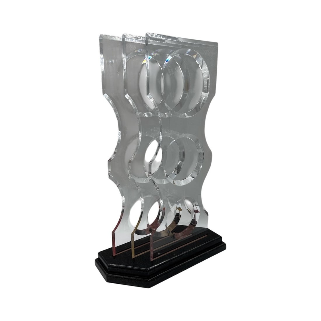 Modernist Abstract Geometric Lucite Sculpture on Polished Blackstone Base: This striking contemporary sculpture is a masterful exploration of geometry and light, featuring a vertical composition of translucent acrylic elements. The piece centers on a tall, slender Lucite