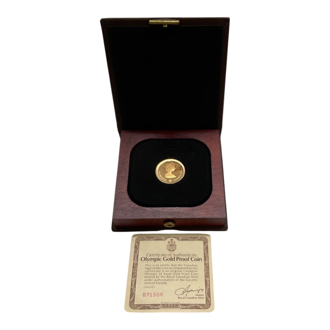 1976 Canadian Olympic 22 Karat Gold Proof Coin in Presentation Case: This official Canadian Olympic gold proof coin was minted by the Royal Canadian Mint to commemorate the 1976 Montreal Olympic Games. Struck in 22 karat gold with a fineness of .9166, the coin weighs