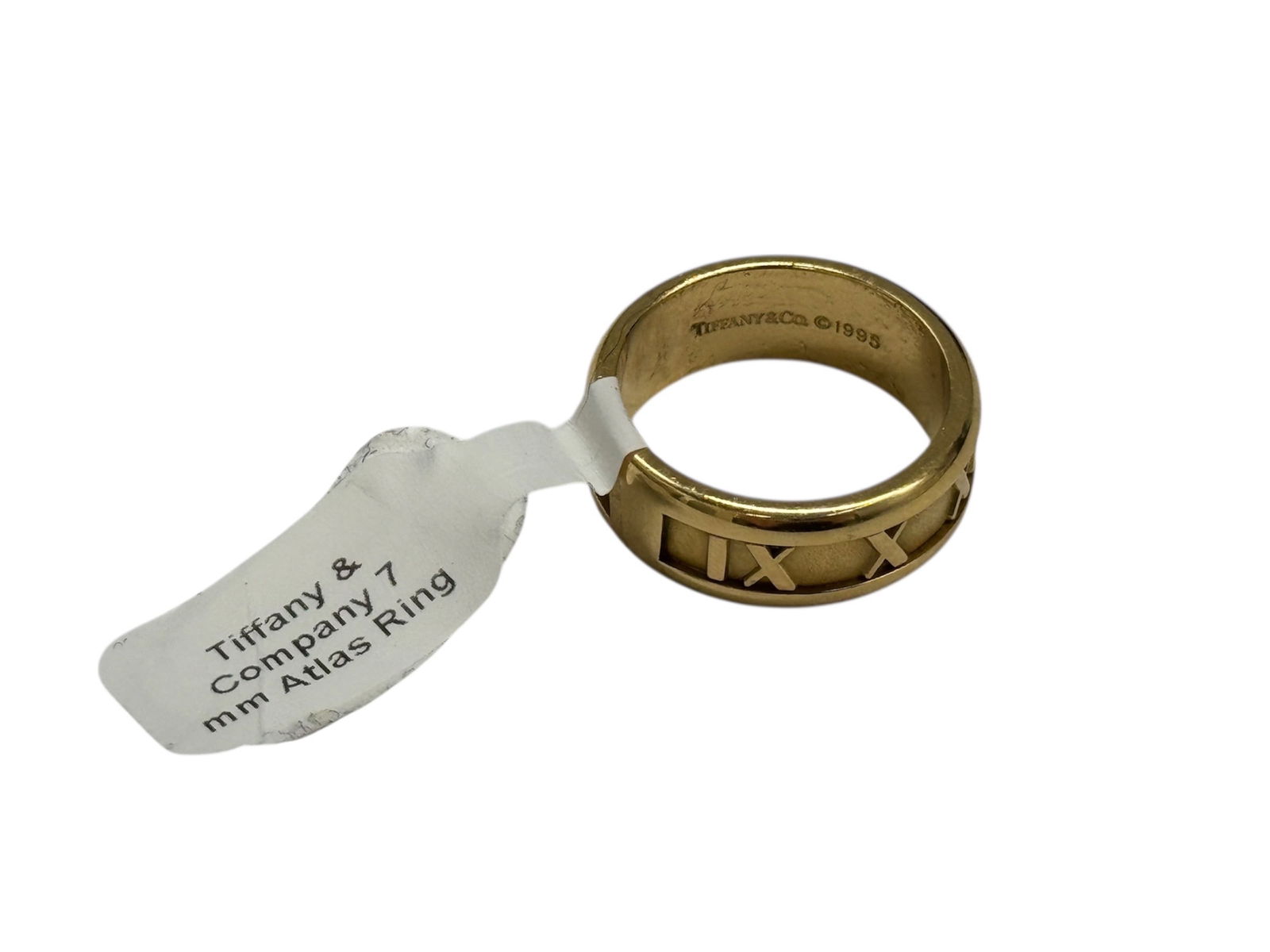 Tiffany & Co Atlas Ring in Yellow Gold: Authentic Tiffany & Co Atlas ring crafted in yellow gold, featuring the iconic Roman numeral motif engraved around the band. This timeless design is part of Tiffany’s well-known Atlas collec