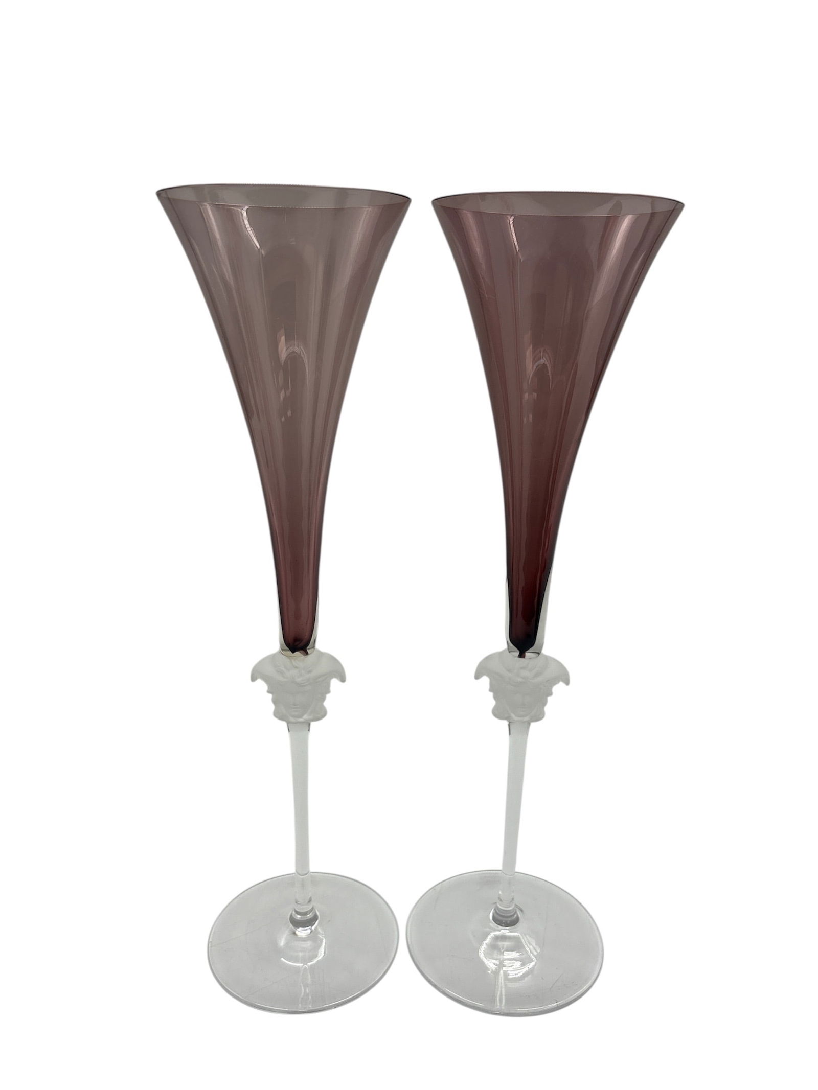 STUNNING Pair of Versace x Rosenthal "Medusa Lumiere Haze" Crystal Champagne Flutes: Description:Elevate your champagne toasts with this exquisite pair of authentic Versace by Rosenthal "Medusa Lumiere Haze" crystal champagne flutes. These are part of the esteemed