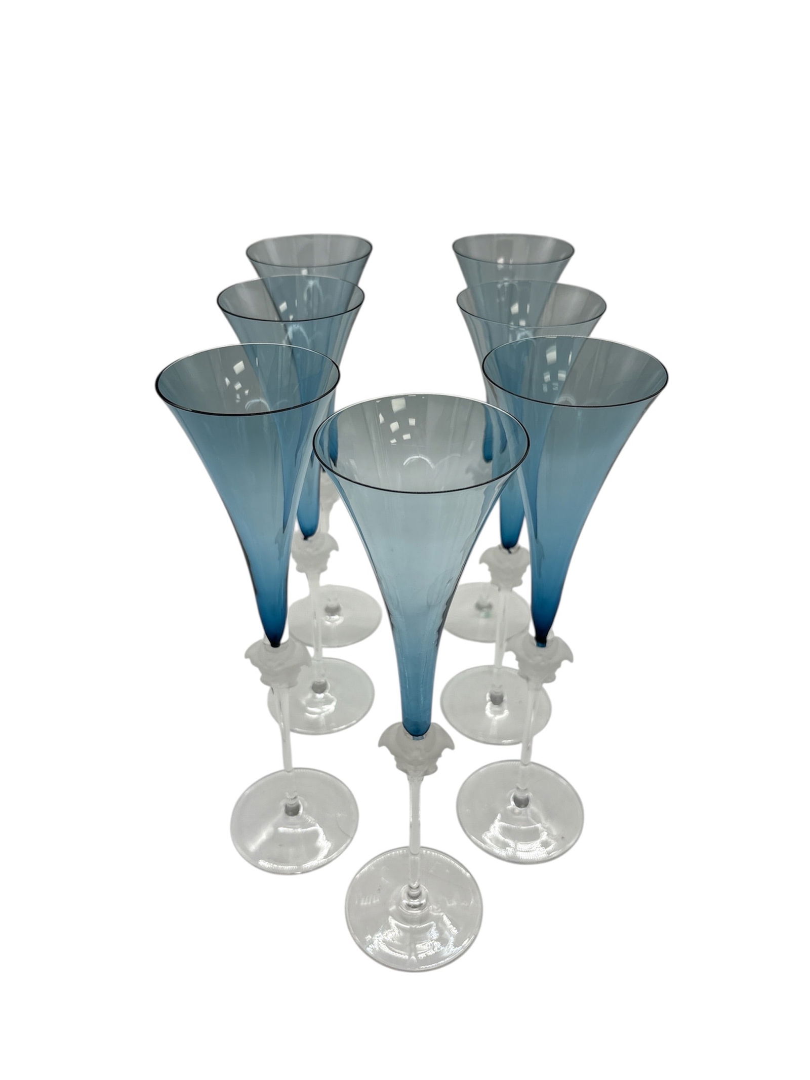 Set of 7 Rosenthal for Versace Medusa Lumiere Petrol Blue Crystal Champagne Flutes: DescriptionA magnificent set of eight (8) crystal champagne flutes from the esteemed collaboration between Rosenthal and Versace. These glasses are part of the iconic "Medusa
