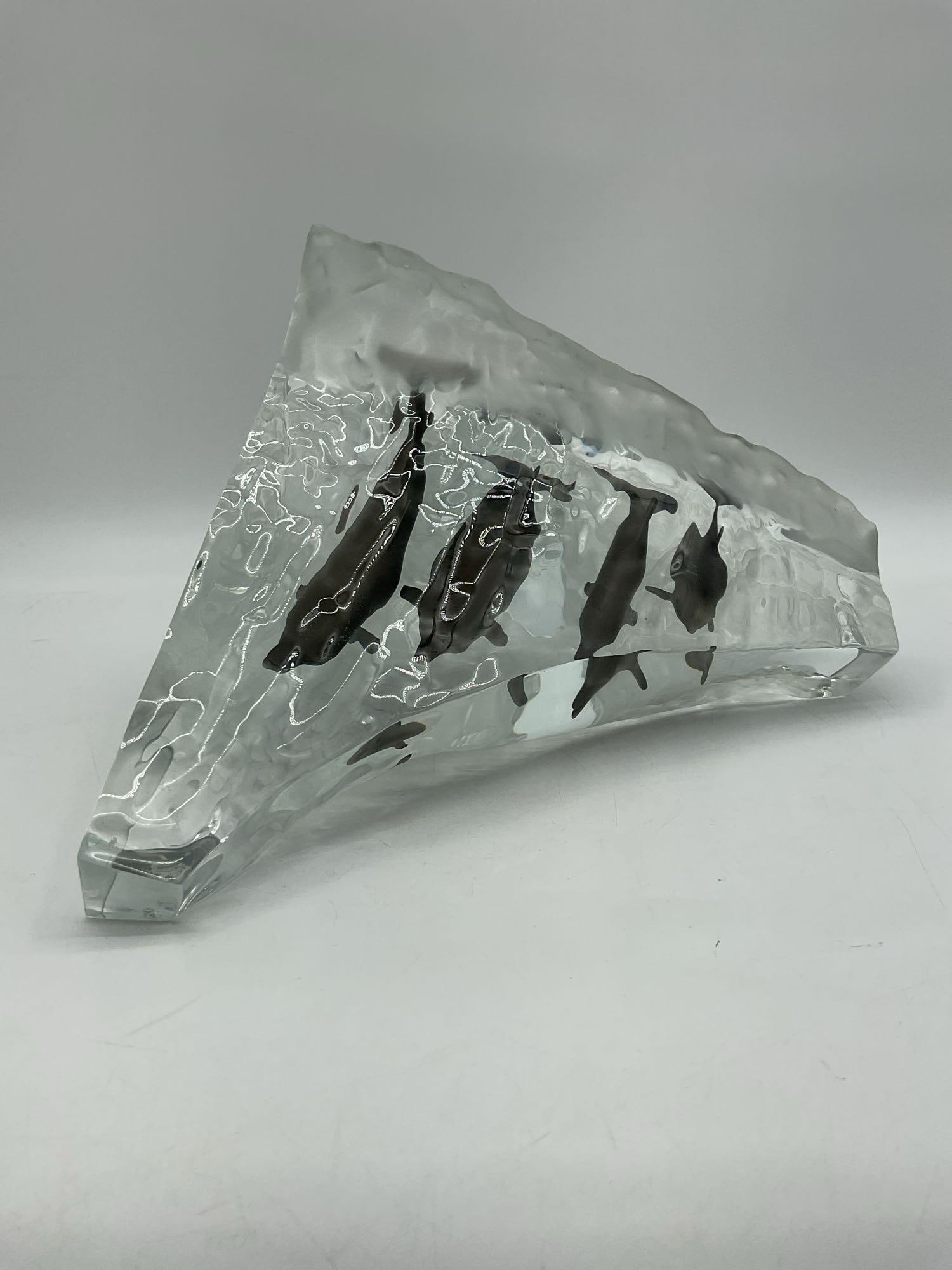 Wyland Bronze Dolphin Sculpture on Lucite Wave Base 1128/1500: Sculpture by Wyland featuring a bronze dolphin captured mid-leap, mounted on a clear lucite base shaped like an ocean wave. Known for his marine life artistry, Wyland combines realistic detail with dy