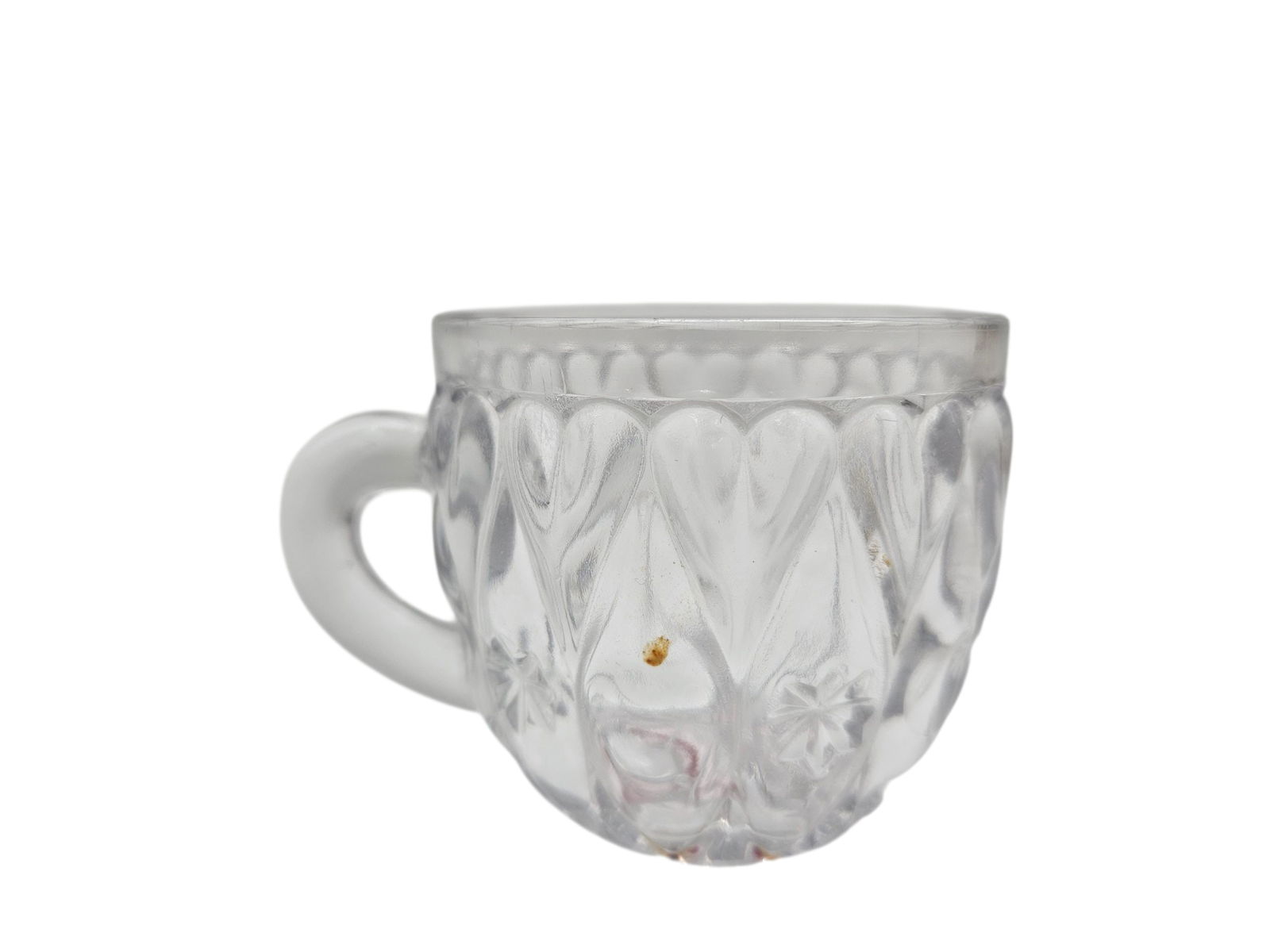 Vintage Pressed Glass Punch Cup: A clear pressed glass cup featuring a heart and starburst motif with a frosted finish on the handle and rim. Likely part of a mid-20th-century punch bowl set, this piece showcases the decorative