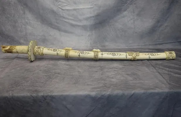 Oriental Bone Sword: Hand carved Oriental bone sword and sheath carving. In excellent condition. Dimensions: L:32in 