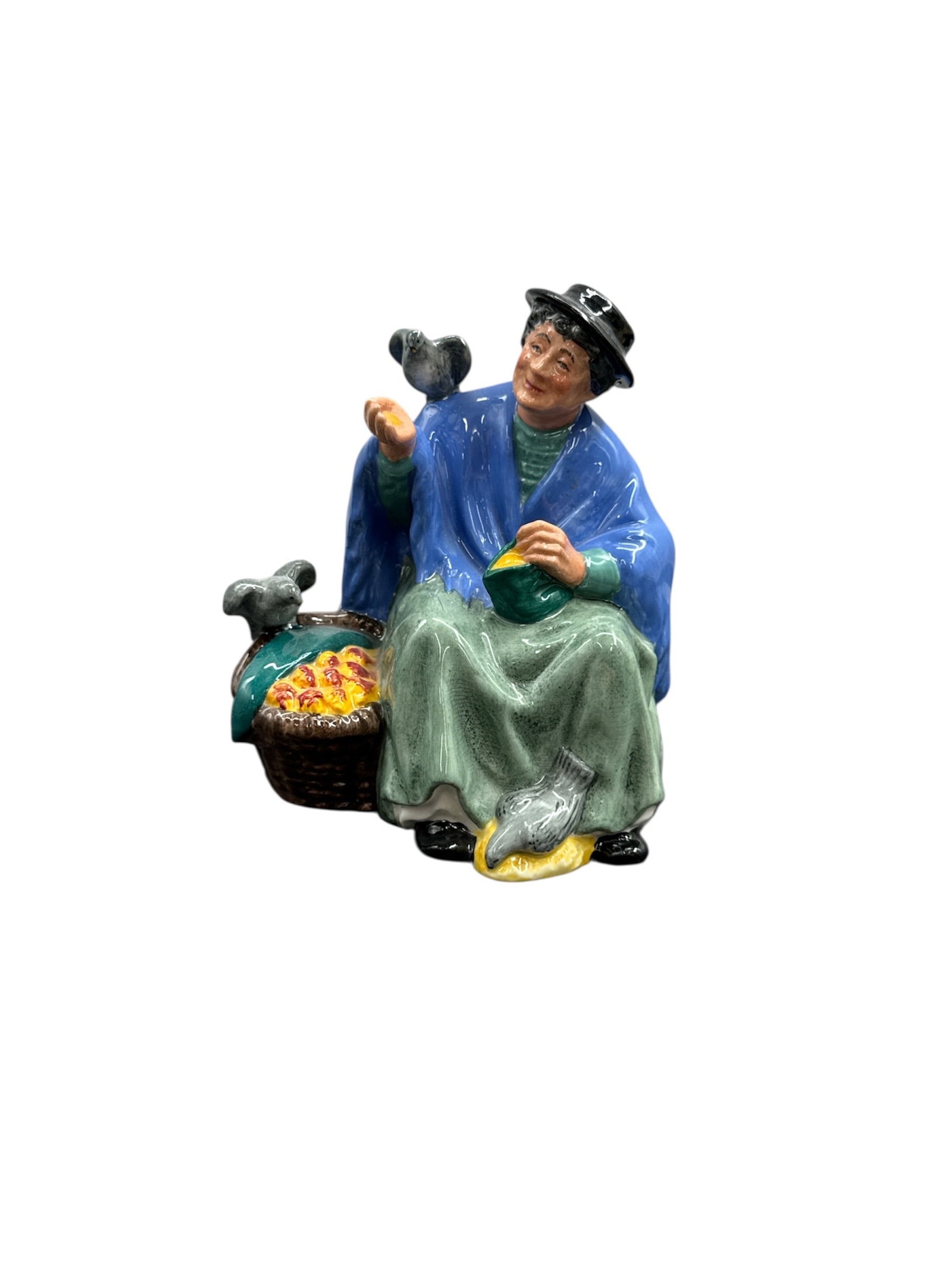 Royal Doulton “Tuppence A Bag?? Figurine – HN 2320 Bone China Dickens Character: This finely modeled Royal Doulton bone china figurine titled “Tuppence A Bag” depicts a classic street vendor character inspired by Charles Dickens–era Lond