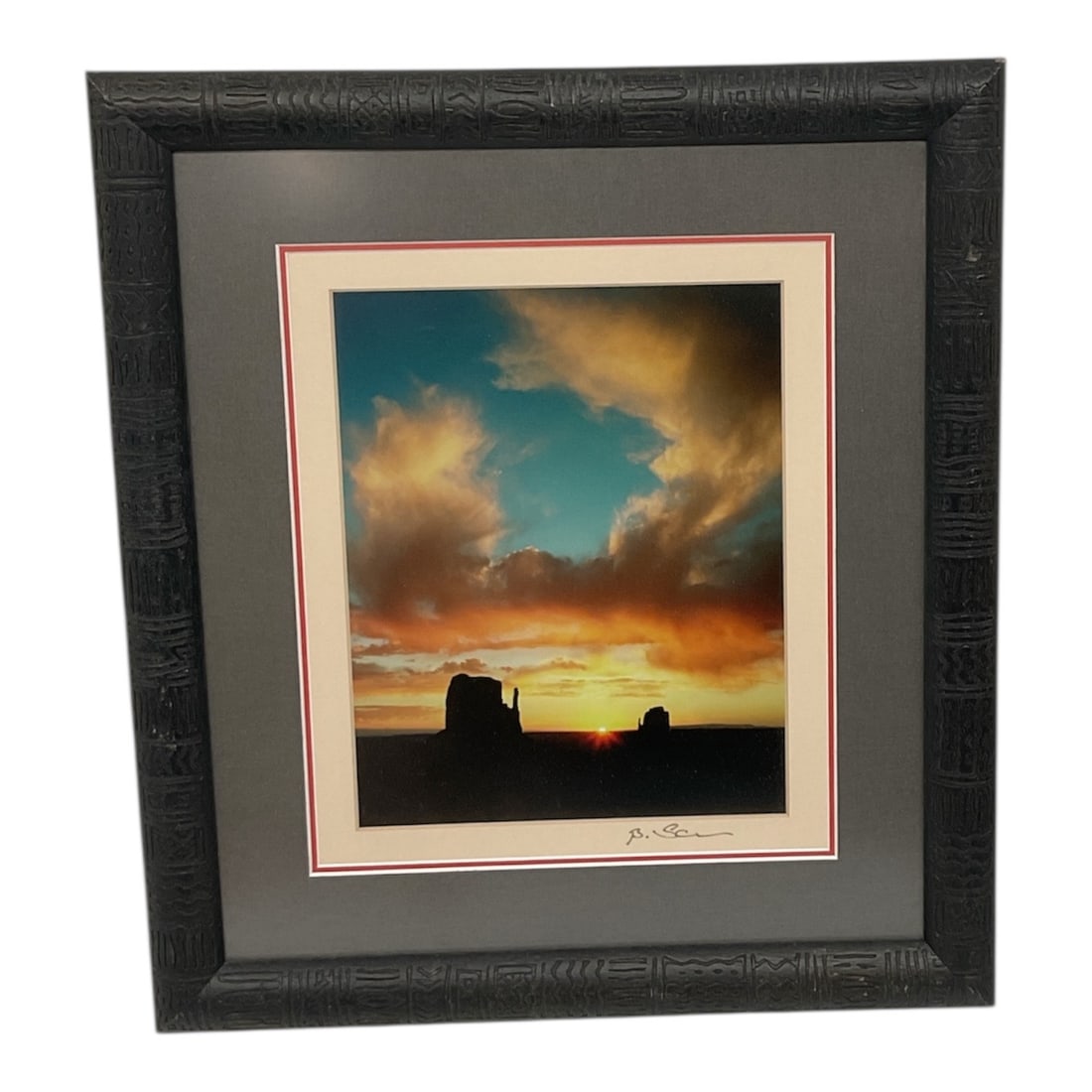 Bo Svensson Framed Landscape Photograph with Monument Valley Silhouette: This framed photographic print by Bo Svensson presents a dramatic sunset landscape featuring silhouetted rock formations against a glowing sky, evoking the vast openness of the American Southwest.