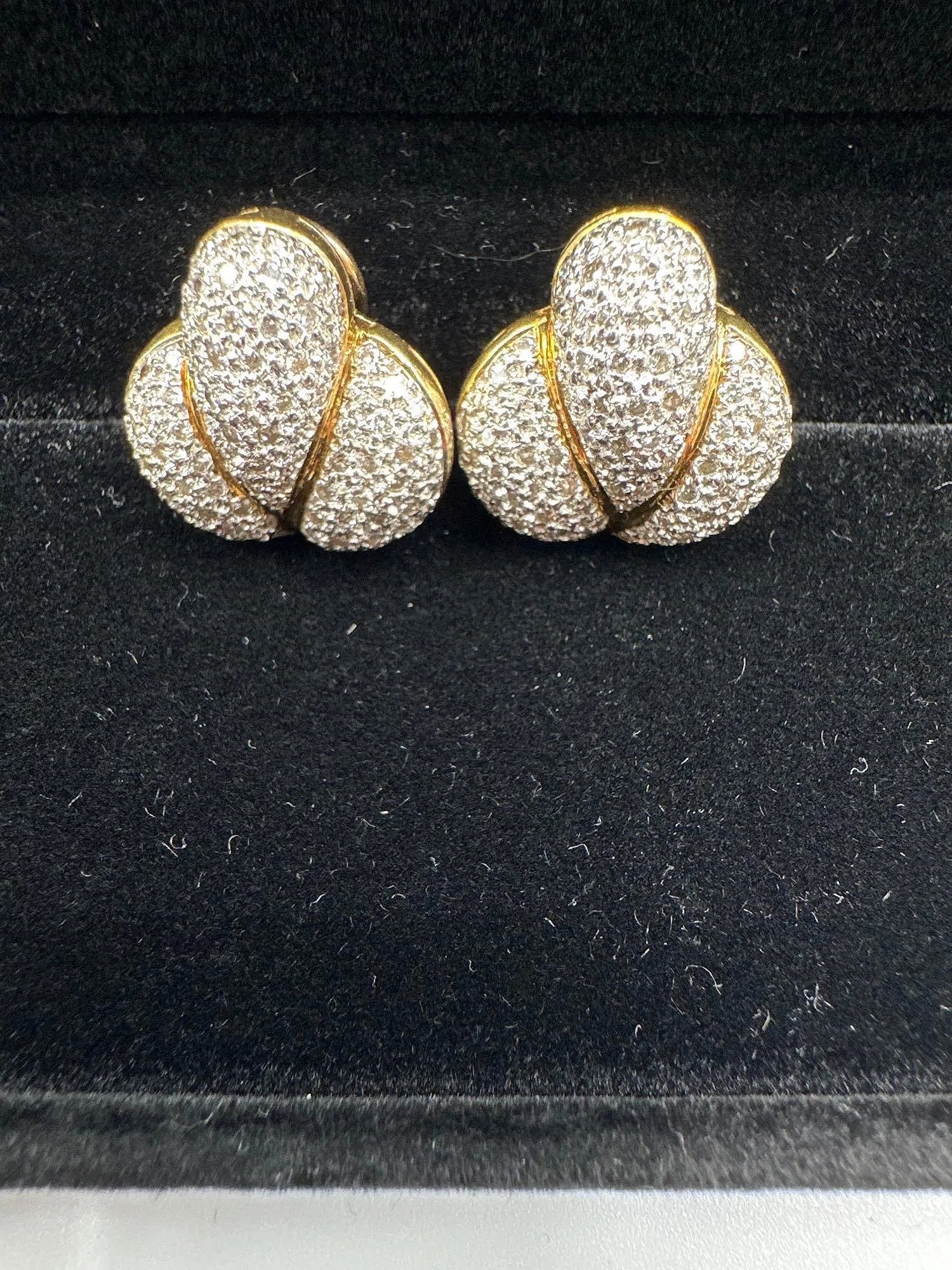 14kt Gold Diamond Pave Clip-On Earrings: These elegant earrings are crafted in 14kt yellow gold and feature a distinctive triple-dome design, fully encrusted with pave-set round brilliant diamonds. The graceful curves are accentuated by poli