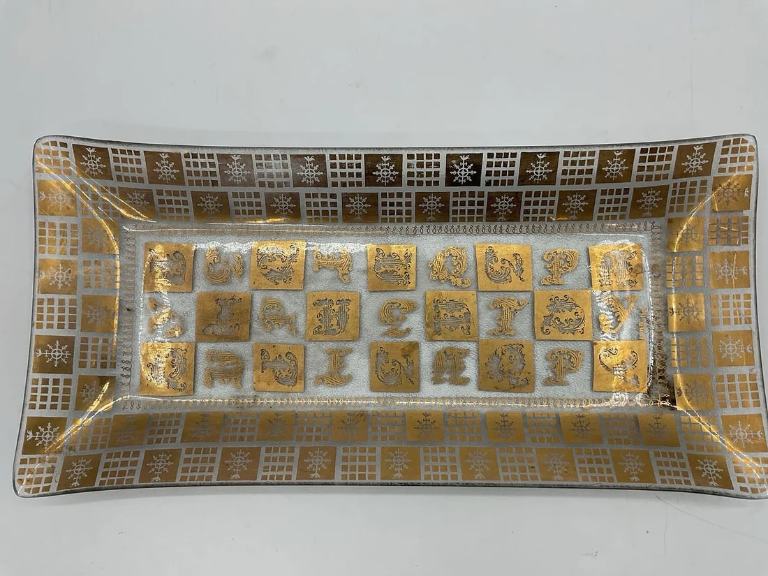 Mid-Century Modern Zodiac Tray by Georges Briard: Features a distinctive sun and lyre motif, often associated with classical themes, along with geometric patterns on the border. Georges Briard rectangular bent glass tray with a gold sun and lyre moti