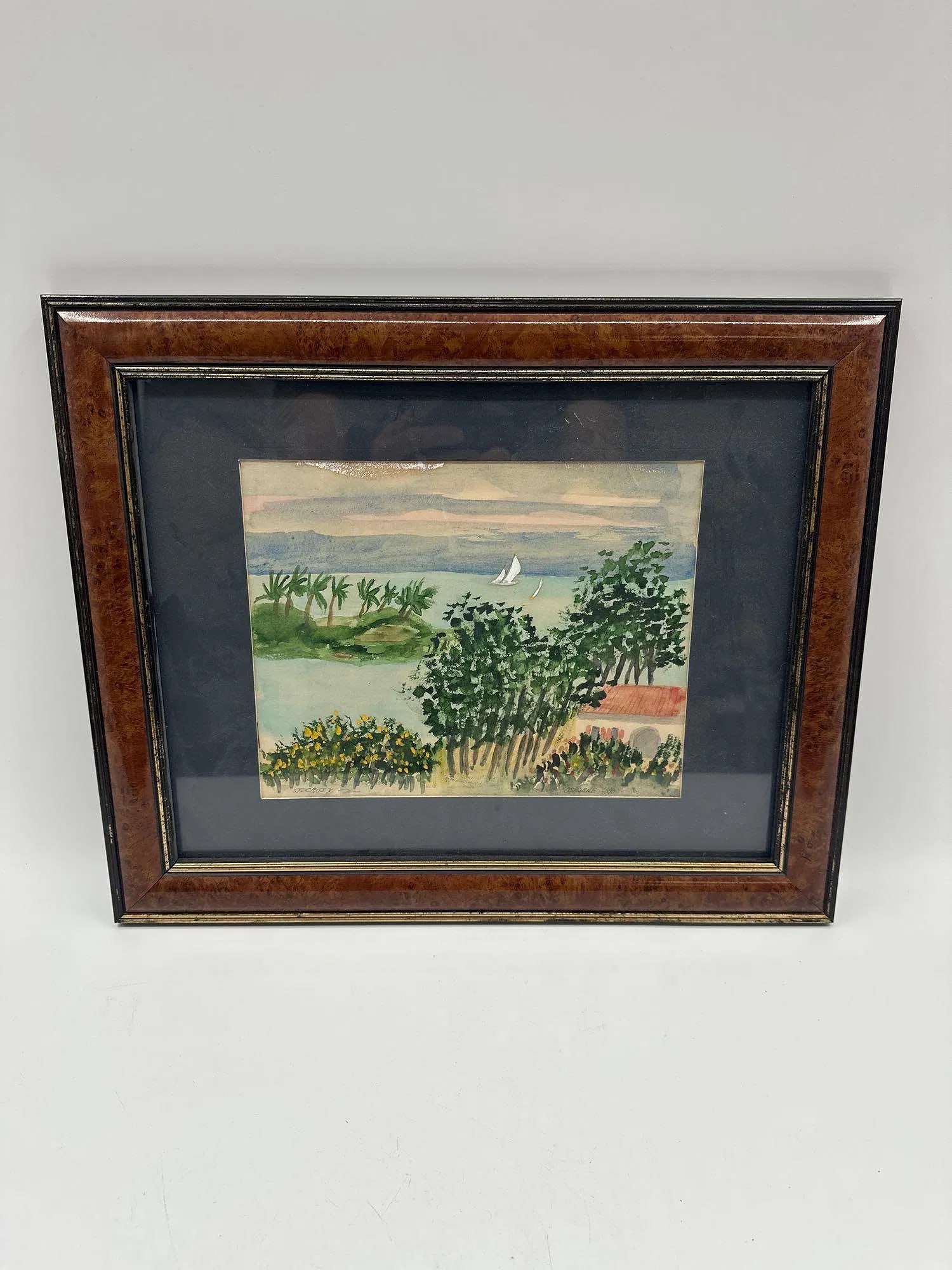Coastal Landscape Scene by Elizabeth Osborne (American, b.1936) Watercolor: Framed watercolor painting depicting a tropical coastline with palm trees, sailboats, and flowering bushes. Soft pastel sky contrasts with lush green foliage and a calm ocean backdrop.Medium: