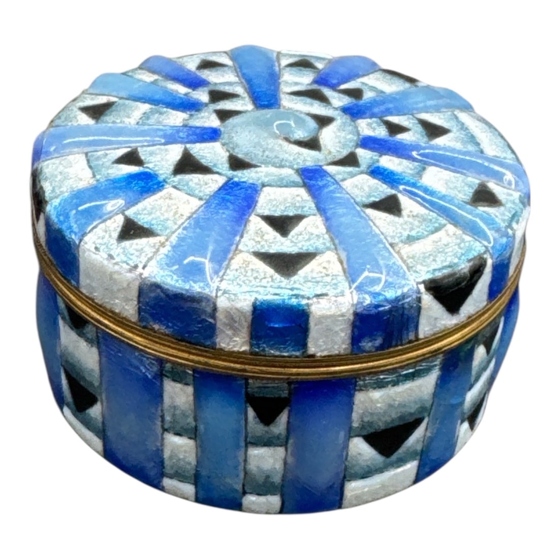 Faure Blue and Silver Mosaic Style Round Trinket Box with Brass Interior: This decorative round trinket box by Faure features a striking blue and silver mosaic style exterior with geometric striping and a radiating sunburst pattern across the lid. The bold design combines t