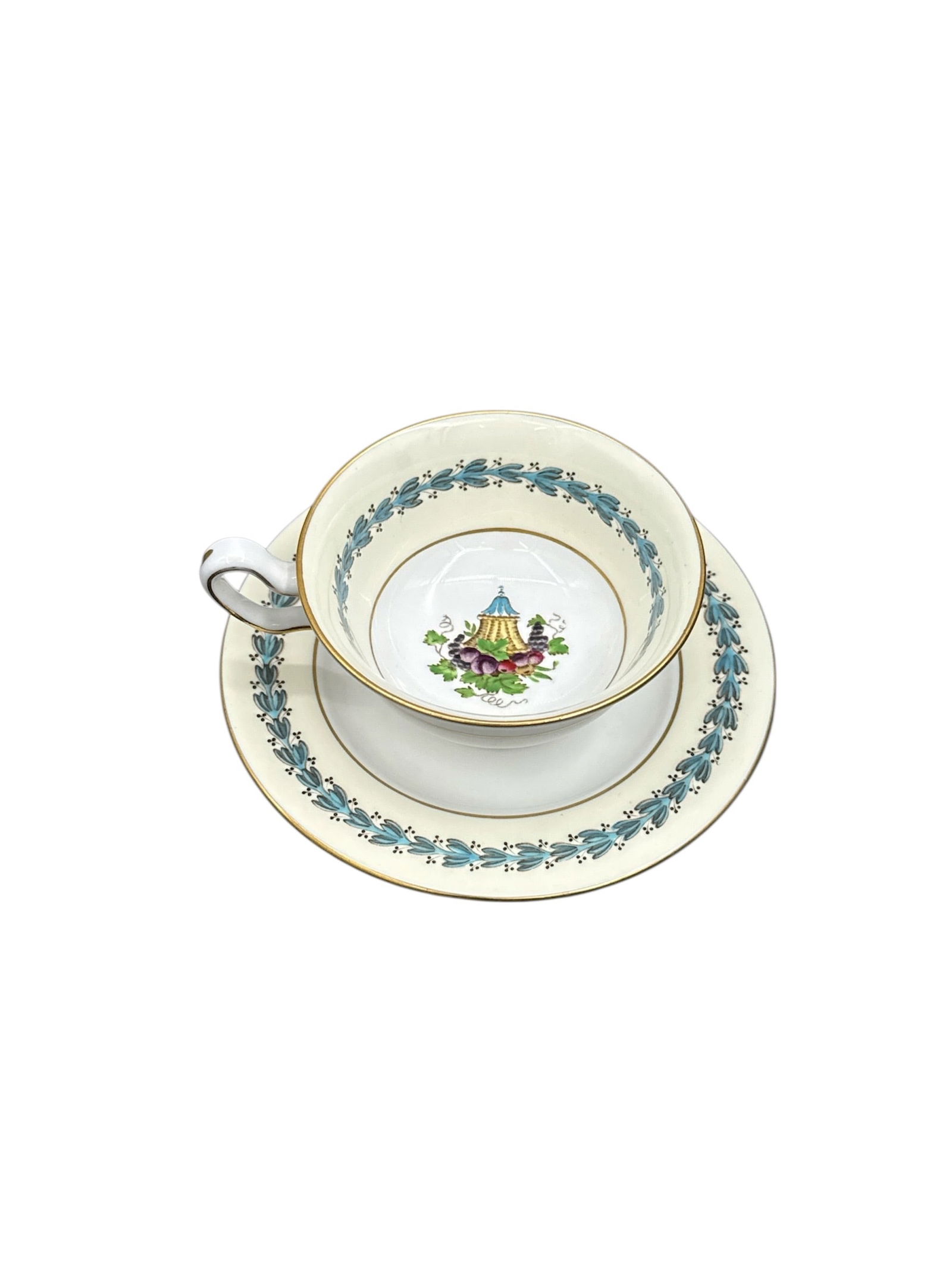 Wedgwood Bone China Appledore Cup and Saucer Set: This elegant Wedgwood bone china cup and saucer set is decorated in the Appledore pattern, featuring a delicate central floral bouquet framed by a soft green border with stylized foliate motifs. The w