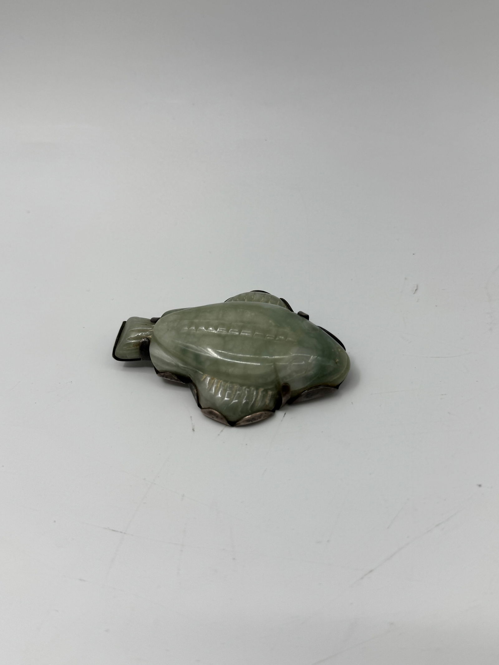 Mexican Sterling Silver Fish Brooch with Nephrite Inlay: Marked "Made Mexico Sterling", fish-shaped with detailed silverwork and mottled green nephrite.Weight 27g2.5in long