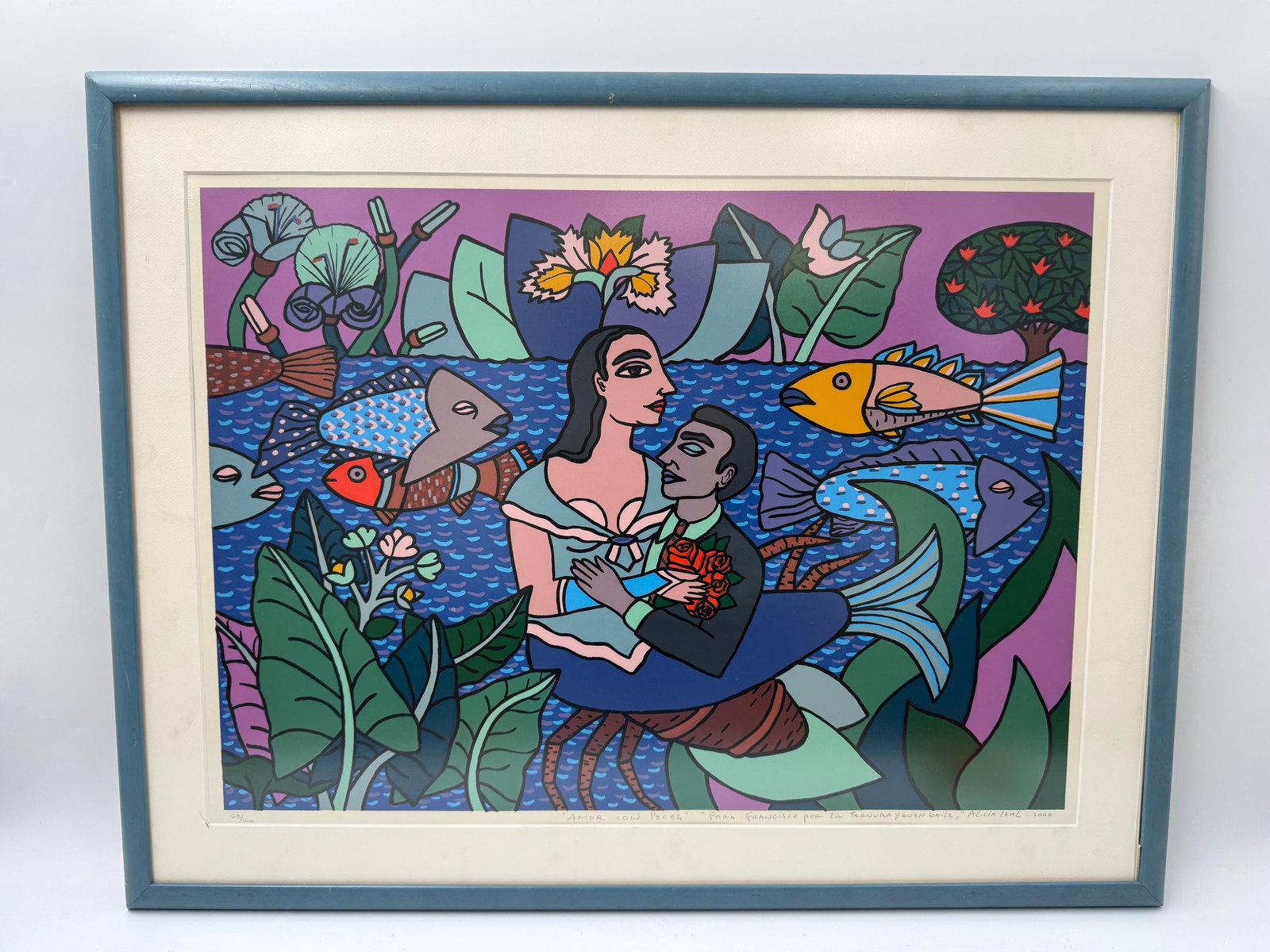 "Amor Con Peces" by Alicia Leal (Cuba, b.1957) Lithograph: Description: Framed print titled "Amor Con Peces" by Alicia Leal. The print depicts a couple with a child surrounded by fish and flora in a vibrant, colorful style. Signed and numbered
