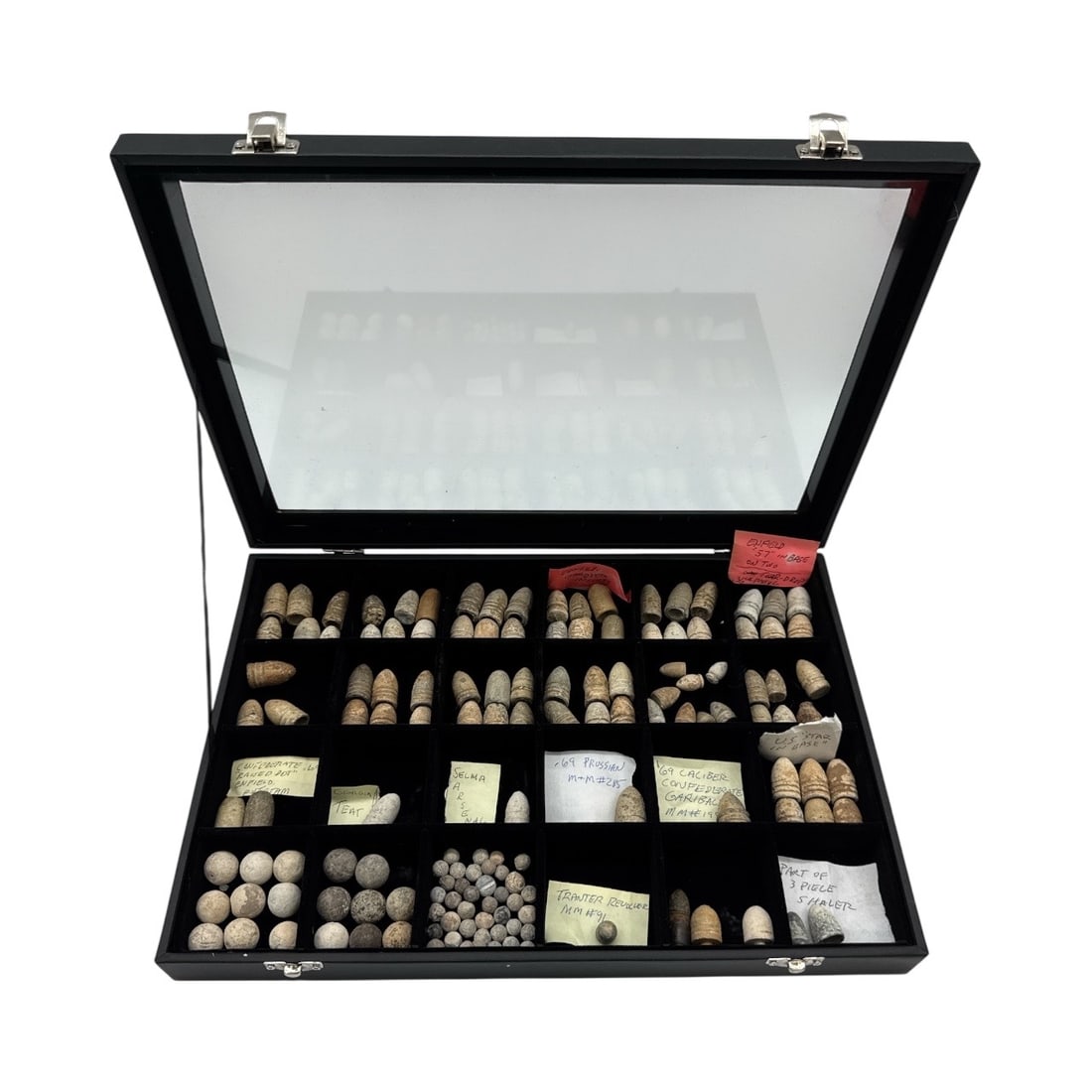 Civil War Bullet and Relic Collection in Display Case: Extensive collection of Civil War-era bullets and round shot presented in a glass-top display case. Includes a variety of fired and dropped lead projectiles such as Minie balls, round balls, and assor