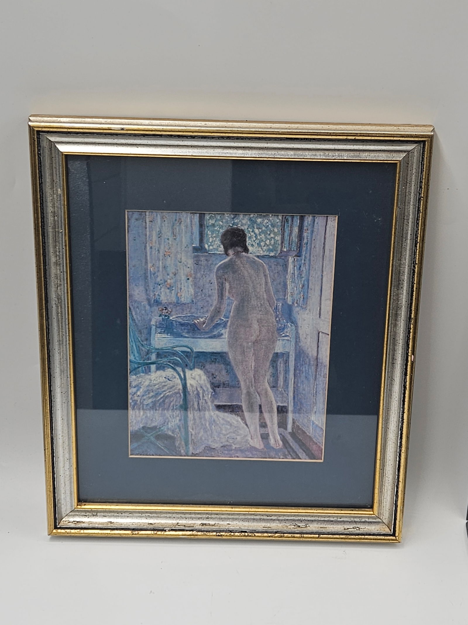 Morning Toilet by Fredrick Carl Frieseke Print: Elegant framed print or pastel depicting a nude woman standing by a window in a softly lit interior. The composition features delicate impressionistic brushwork in cool tones of blue and lavender,