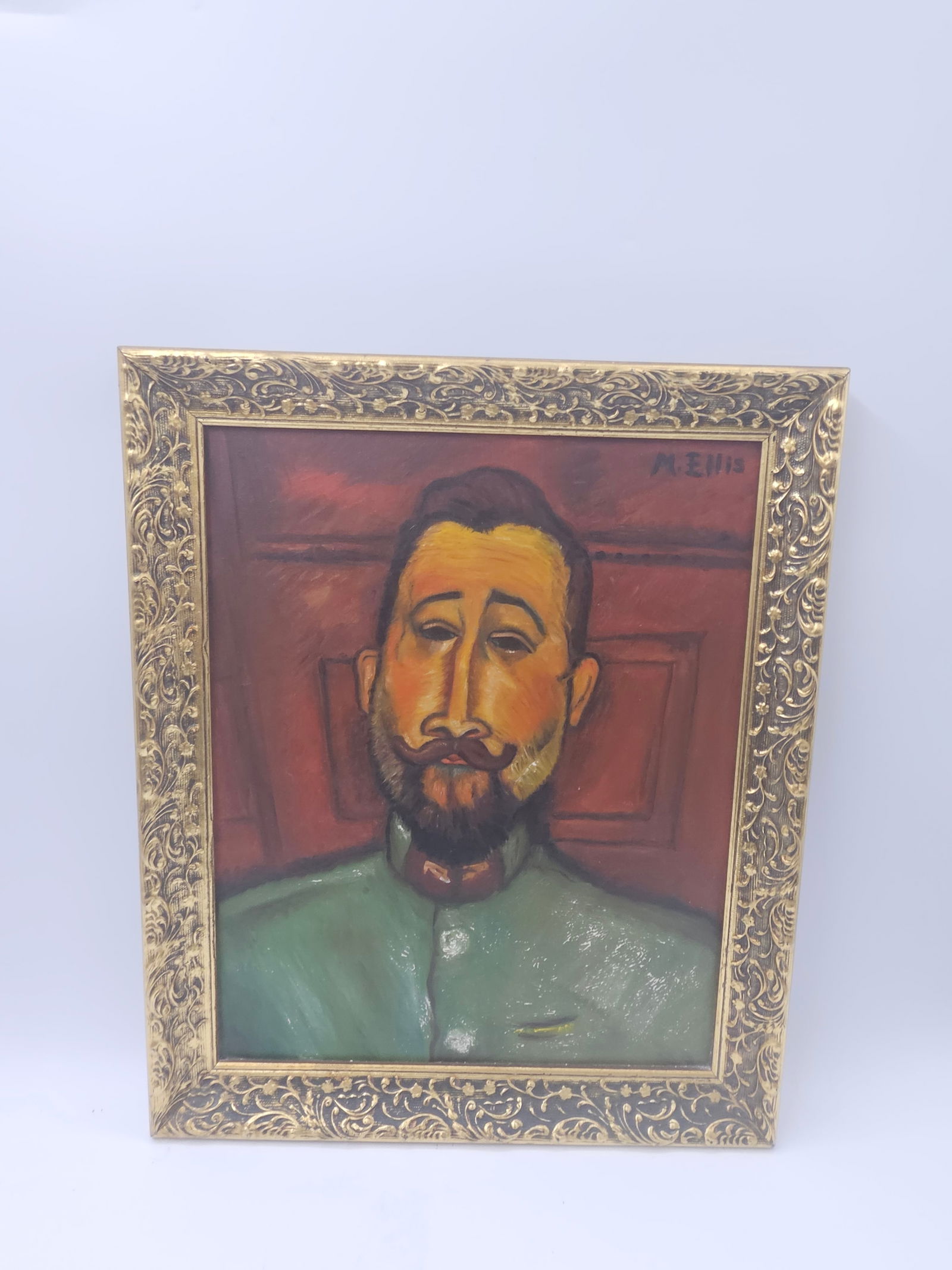 Portrait of a Bearded Man by M. Ellis: Description: Expressive modernist portrait painting of a bearded man in a green shirt against a warm-toned background. The stylized facial features and bold color palette evoke the influence of early