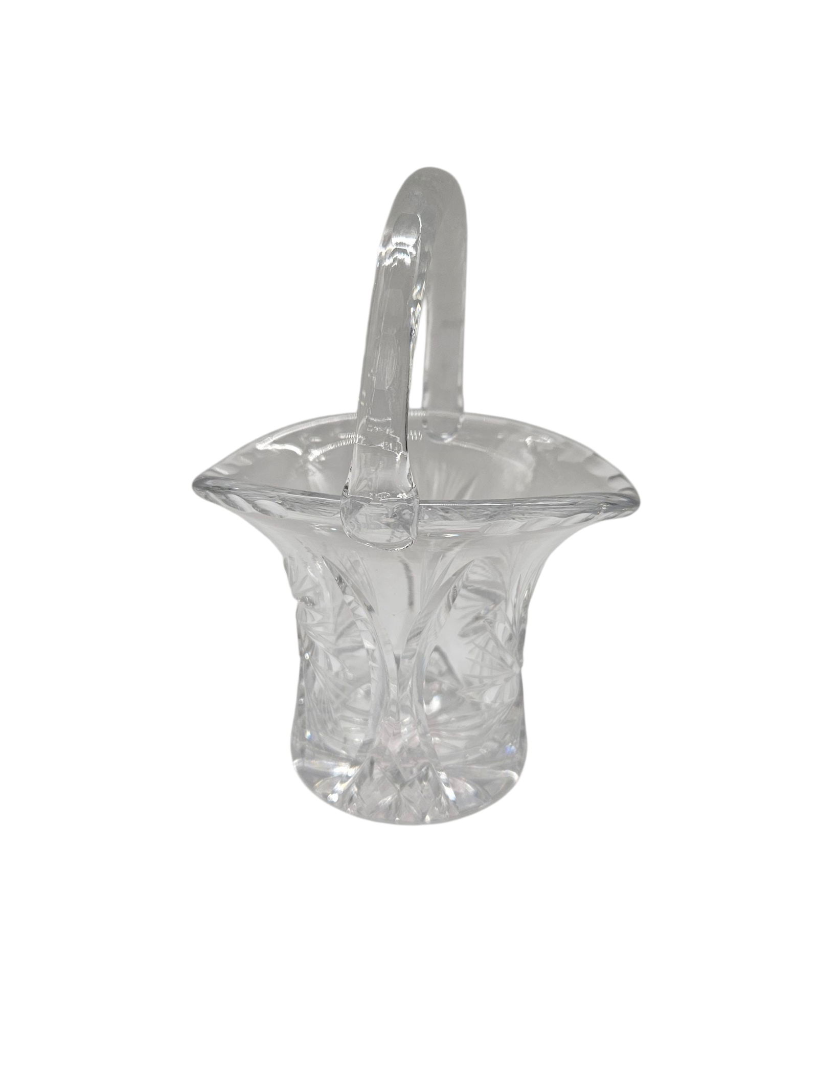 Cut crystal basket: Small clear cut crystal basket with flared rim and applied handle, decorated with fan and star style cuts, likely a decorative candy or nut dishDimensions: H: 6 in Diameter: 5 in