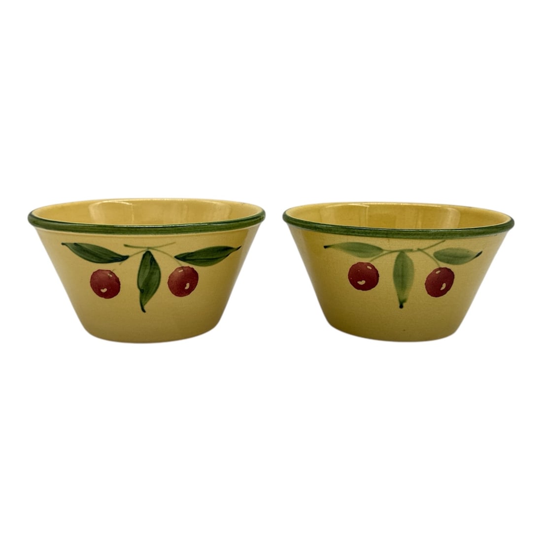 Pair of Pizzato Handmade Hand-Painted Ceramic Bowls with Cherries: Charming pair of handmade ceramic bowls, each hand-painted with a simple cherry and leaf motif on a warm yellow ground with green rim detailing. Marked on the underside “