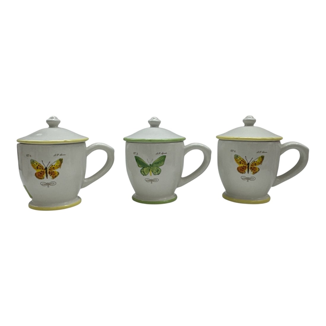 Set of Three Williams-Sonoma Butterfly Lidded Mugs (2008): Charming set of three lidded ceramic mugs made exclusively for Williams-Sonoma (dated 2008). Each mug features a colorful butterfly motif on the front with coordinatin