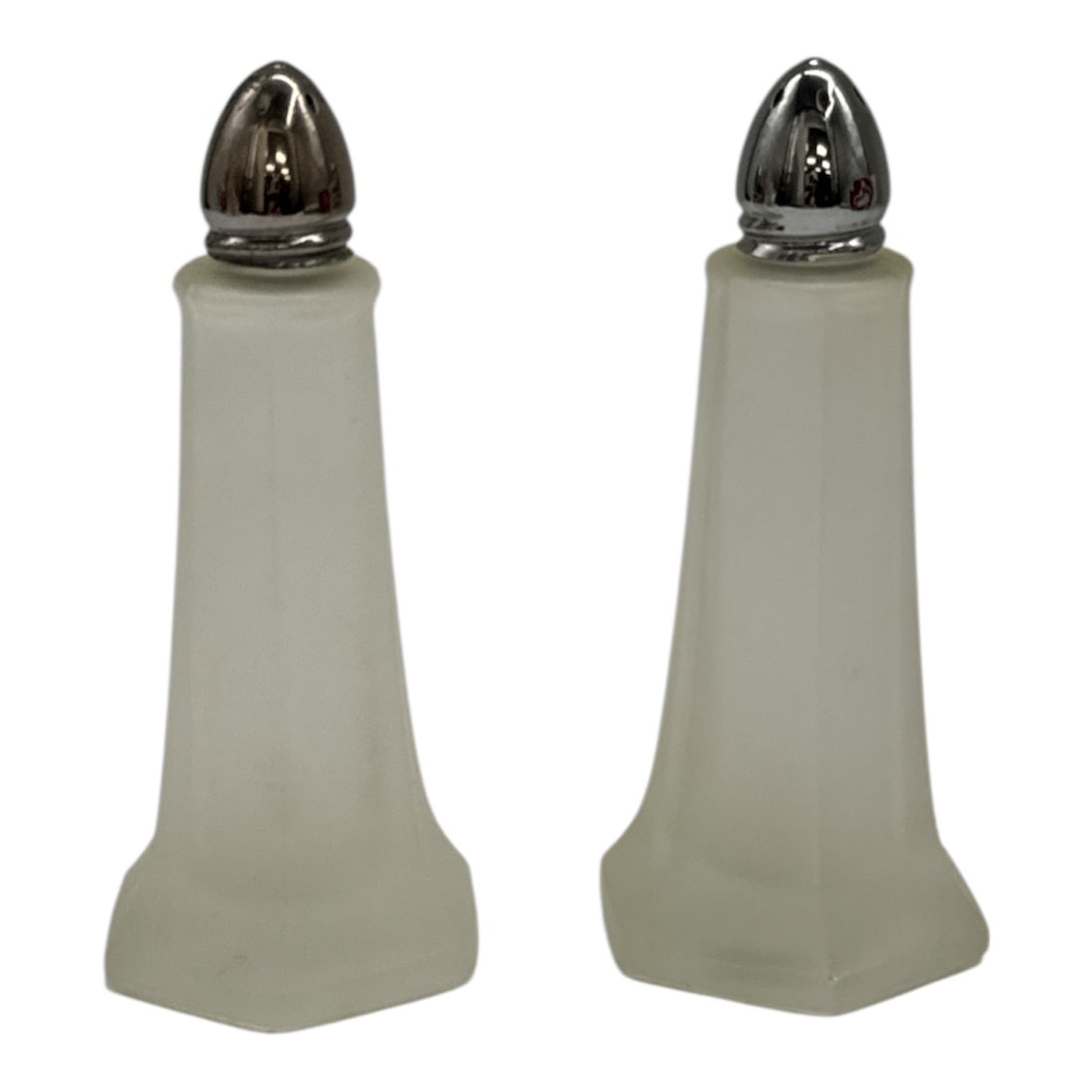 Pair of Frosted Glass Salt and Pepper Shakers with Chrome Tops: Simple and elegant pair of frosted glass salt and pepper shakers featuring tapered square-form bodies and shiny chrome-plated tops. A classic minimalist design suitable for modern or vintage table set