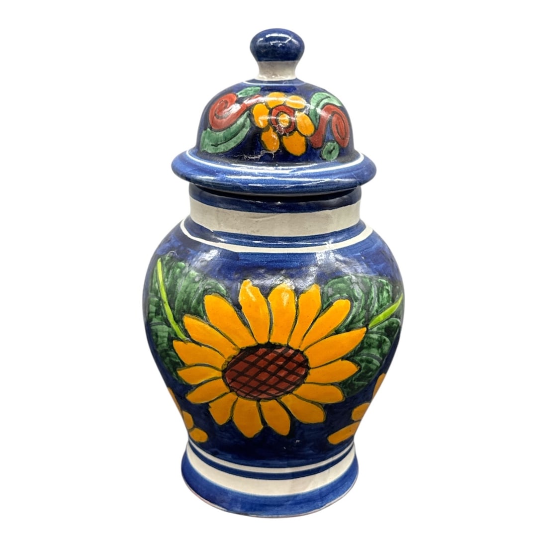 Hand Painted Decorative Ceramic Lidded Jar with Sunflower Motif: Hand painted ceramic lidded jar featuring a vibrant sunflower motif rendered in yellow and green against a deep blue ground. The jar is decorated throughout with bold floral imagery and finished with