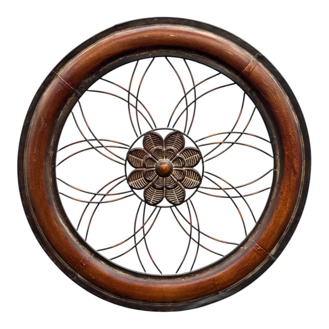 Decorative Circular Metal Wall Art with Floral Motif: Decorative circular wall art crafted in metal, featuring an openwork floral motif at the center with radiating curved lines extending to the surrounding ring. Finished in contrasting dark and warm bro