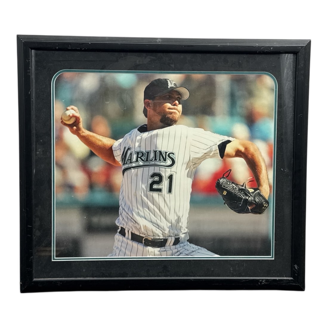 Framed Florida Marlins Pitcher Photograph No. 21 Action Shot: Large framed sports photograph featuring a Florida Marlins pitcher wearing jersey number 21 captured mid-throw on the mound. The vivid action image and classic team uniform make this an excellent disp
