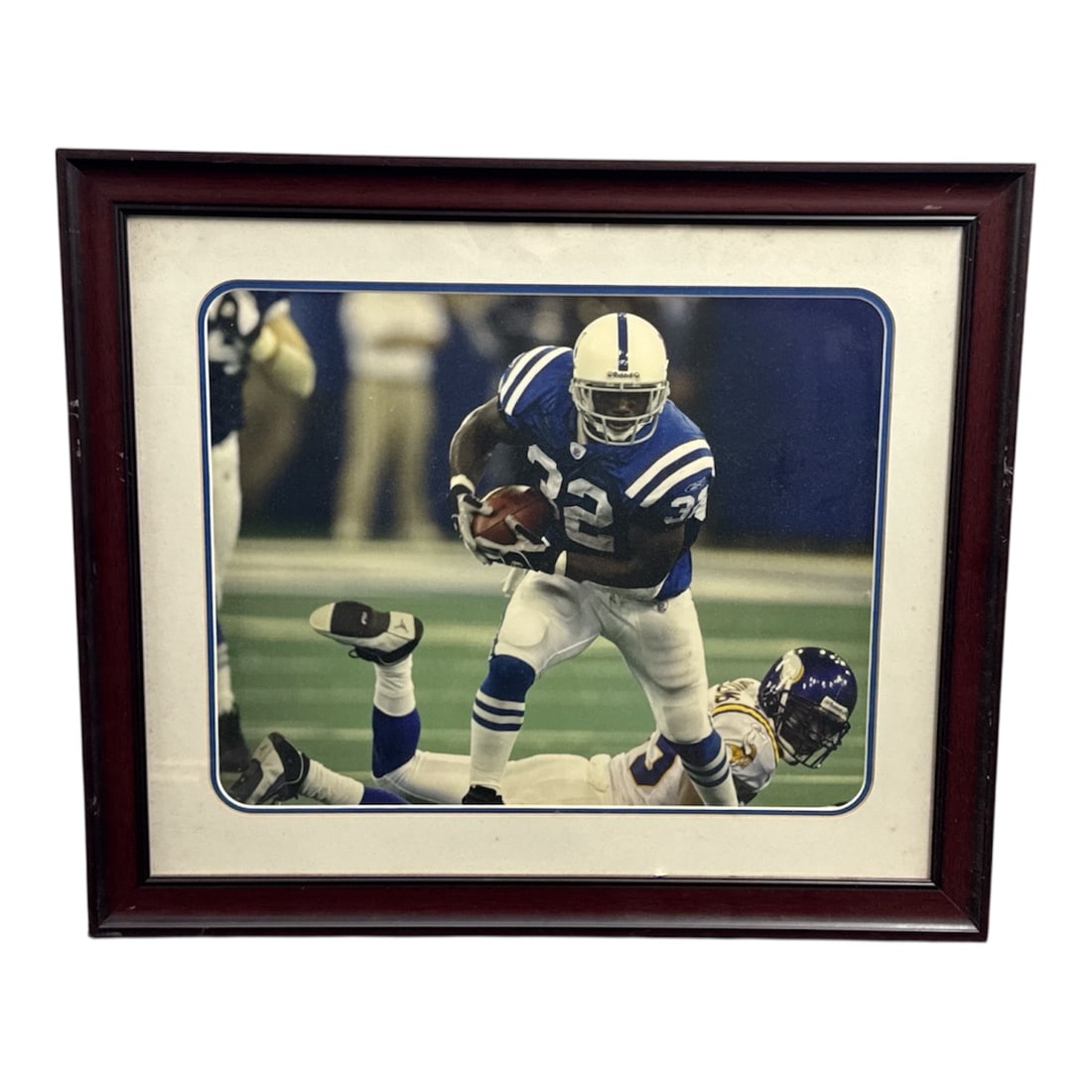 Framed Indianapolis Colts Football Action Photograph: Large framed action photograph featuring an Indianapolis Colts player in motion during a game, captured in a dynamic on-field moment. Presented in a dark wood frame with wide matting, this piece is id
