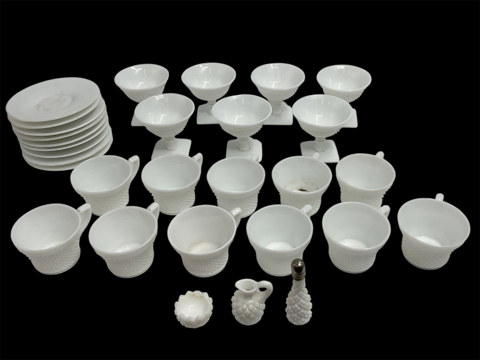 Antique Milk Glass Hobnail Punch Bowl Set with Saucers and Sherbet Glasses: An antique milk glass punch bowl set featuring the classic Hobnail pattern, including matching saucers, handled cups, and sherbet glasses. The opaque white glass displays raised hobnail texture throug