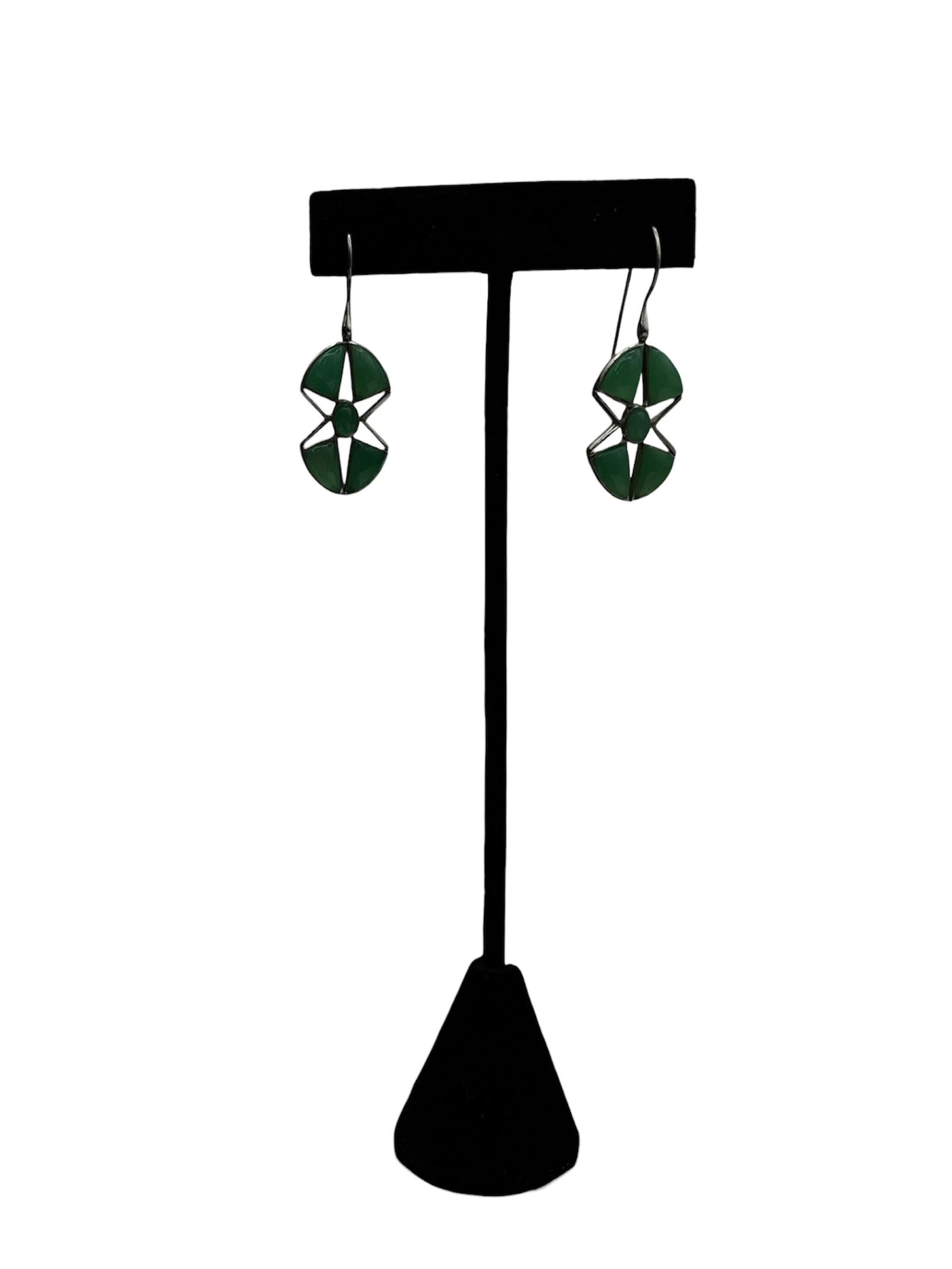 Chrysoprase Green Earrings and Ailver: These earrings are handmade geometric dangle earrings featuring a dark green, star-like cutout design, similar in style to products offered by artisan jewelry collections. 