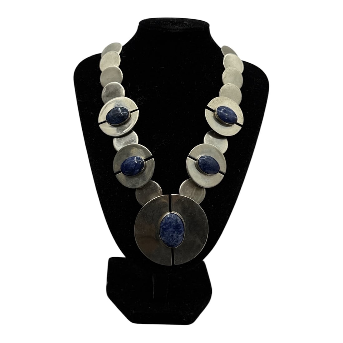 Silver and Lapis Statement Necklace: Vintage artisan-crafted silver and lapis lazuli statement necklace. Based on similar high-end items, this necklace features a bold, geometric