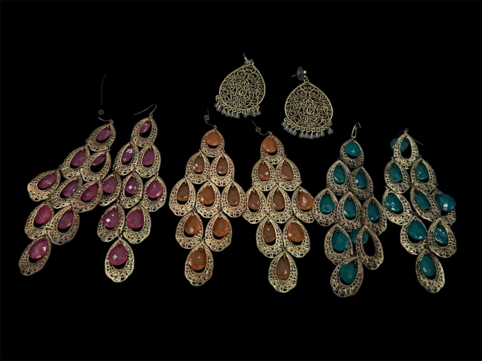 Vintage Costume Chandelier Earrings: These items are chandelier-style statement dangle earrings featuring filigree metalwork and colorful teardrop-shaped gemstones