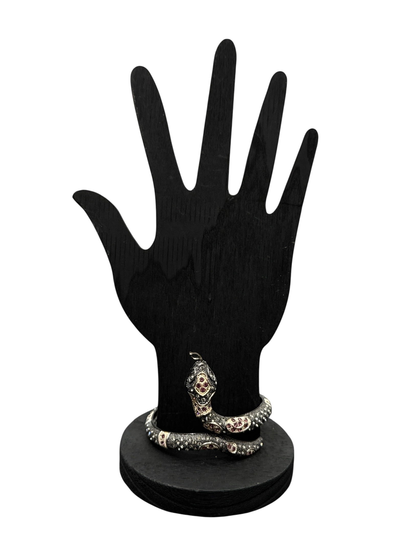 Serpent-motif Bangle: Serpent-motif bangle or wrap-around snake bracelet. This style is characterized by a flexible, coiled design that mimics the natural movement of a snake.Key Descriptive